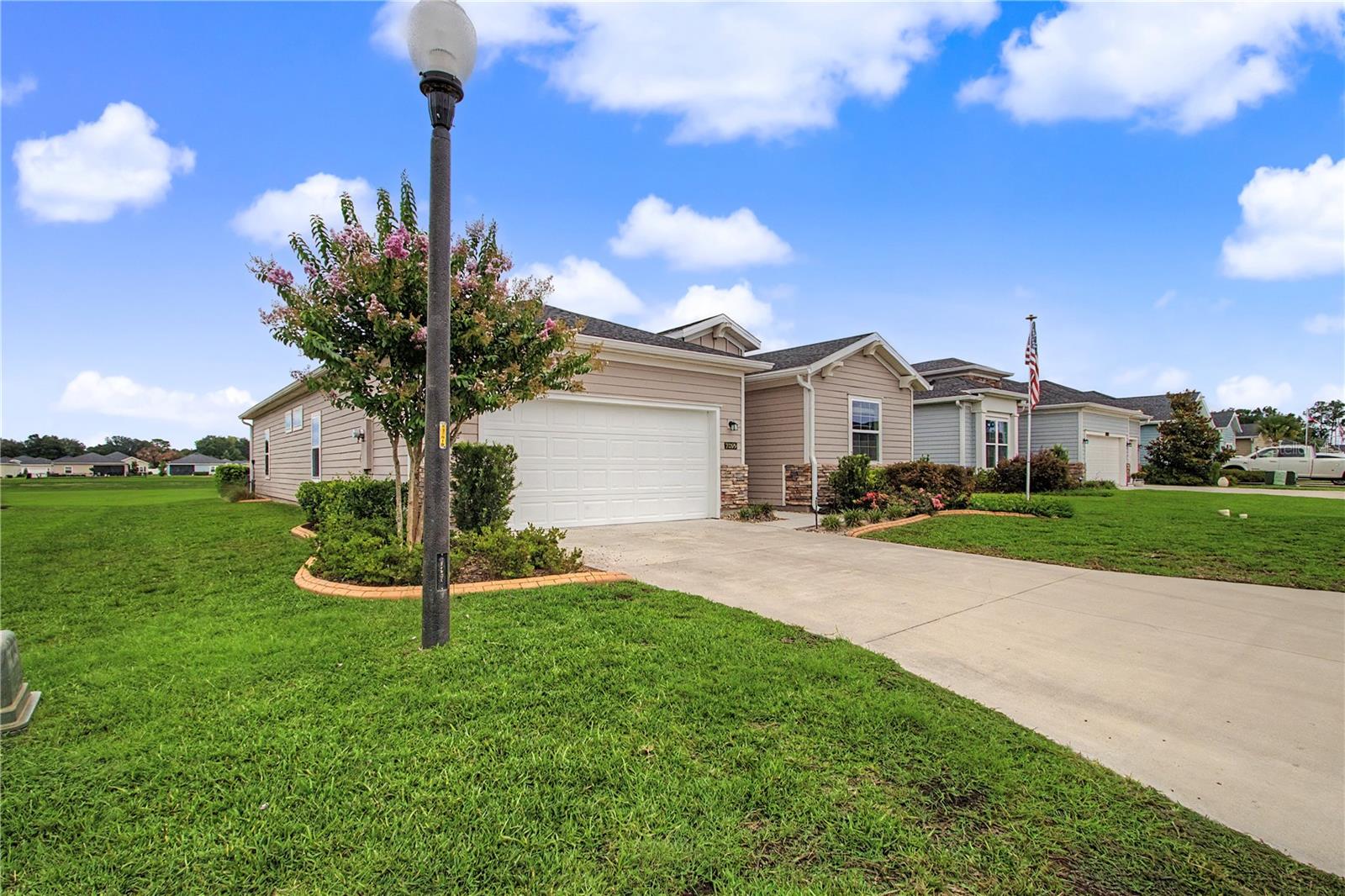 FULLY FURNISHED and move-in ready, this exceptional residence offers the perfect combination of luxury, privacy, and effortless Florida living.  Homesite backs to a tranquil common area. Inside the home, you'll find a beautifully appointed open-concept design filled with natural light and upscale finishes throughout. The gourmet kitchen is the heart of the home, featuring 42-inch white cabinetry with crown molding, stunning quartz countertops, and an oversized island that invites family gatherings and entertaining. A dramatic rolling wall of glass opens to the covered, glass-enclosed lanai, seamlessly blending indoor and outdoor living while showcasing the peaceful backyard setting. Wood-look tile flooring flows throughout the main living areas, adding warmth, style, and easy maintenance. The thoughtfully designed floor plan offers 3 spacious bedrooms, a private den with a barn door perfect for a home office or hobby room, and 3 full bathrooms. The luxurious owner's suite features a generous walk-in closet, dual vanities, and a large walk-in shower designed for comfort and convenience. Located in a sought-after resort-style community, residents enjoy exceptional amenities including a sparkling pool, covered pavilion, pickleball, bocce, and shuffleboard courts. Conveniently located near shopping and dining, and just minutes from the renowned World Equestrian Center, this fully furnished home offers a rare opportunity to enjoy an upscale lifestyle from day one—simply bring your suitcase and start living. 55 + community.