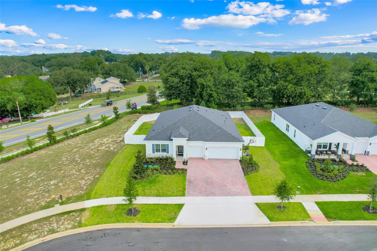 Built in September 2025, this exceptional 4-bedroom, 3-bath home with a dedicated flex room offers a combination of privacy, space, and luxury that is rarely found in today's new construction communities. Situated at the end of a quiet cul-de-sac on a true quarter-acre homesite, this property features no front neighbors, no rear neighbors, and only one side neighbor, creating a setting that feels open and private. Unlike many newer subdivisions where homes are built just feet apart, this property provides room to breathe while offering abundant parking thanks to its unique cul-de-sac location. Even better, you'll enjoy a beautiful lake view from the driveway.

From the moment you open the glass inserted front door and step through the grand foyer, you'll appreciate the attention to detail throughout. Elegant 12x24 vertical tile flooring flows seamlessly through the entire home, creating a clean, modern look with no carpet to maintain. The gourmet kitchen is designed to impress with quartz countertops, a large center island, double ovens, a sleek flat induction cooktop, stainless steel appliances, stylish backsplash, pendant & recessed lighting, and upgraded Sonoma Maple Latte cabinetry topped with crown molding. The kitchen is also equipped with a ventilation fan that exits through the exterior. The walk-in pantry has been enhanced with custom wood shelving for both beauty and function. The entire interior has been repainted with eggshell paint, as opposed to the builders standard flat paint. 

The spacious primary suite is a true retreat, showcasing a tray ceiling with crown molding and a custom-built closet system. The luxurious primary bath offers dual vanities and a large glass-enclosed shower. One of the guest bedrooms features its own private bathroom, making it an ideal in-law suite or private guest quarters.
Plantation shutters have been installed throughout the home, giving it even more of  luxurious and modern ambiance.

Outside, the home's curb appeal shines with a paved driveway, attractive brick accents, and a vinyl-fenced backyard ready for entertaining, pets, or play. Flood lights have also been installed in the backyard. Open the electric roller shade and step outside to the covered patio; a perfect spot to enjoy your morning coffee or evening cocktail. It is also pre-piped and ready for an outdoor kitchen. The garage includes concrete coating and a utility sink!

Located in Clermont, recognized as Florida's #1 suburb and ranked among the nation's top suburbs, you'll be just minutes from the Clermont Chain of Lakes, vibrant Downtown Clermont, shopping, dining, and outdoor recreation. Plus, Walt Disney World and all that the Orlando area has to offer are only about 35 minutes away.

Opportunities to own a nearly new home with this level of privacy, premium upgrades, and oversized homesite are incredibly rare. Over $50,000 in Builder upgrades and an additional $23,000 in upgrades after construction. Don't wait to build, move in next month and get started with the next chapter of your life!
