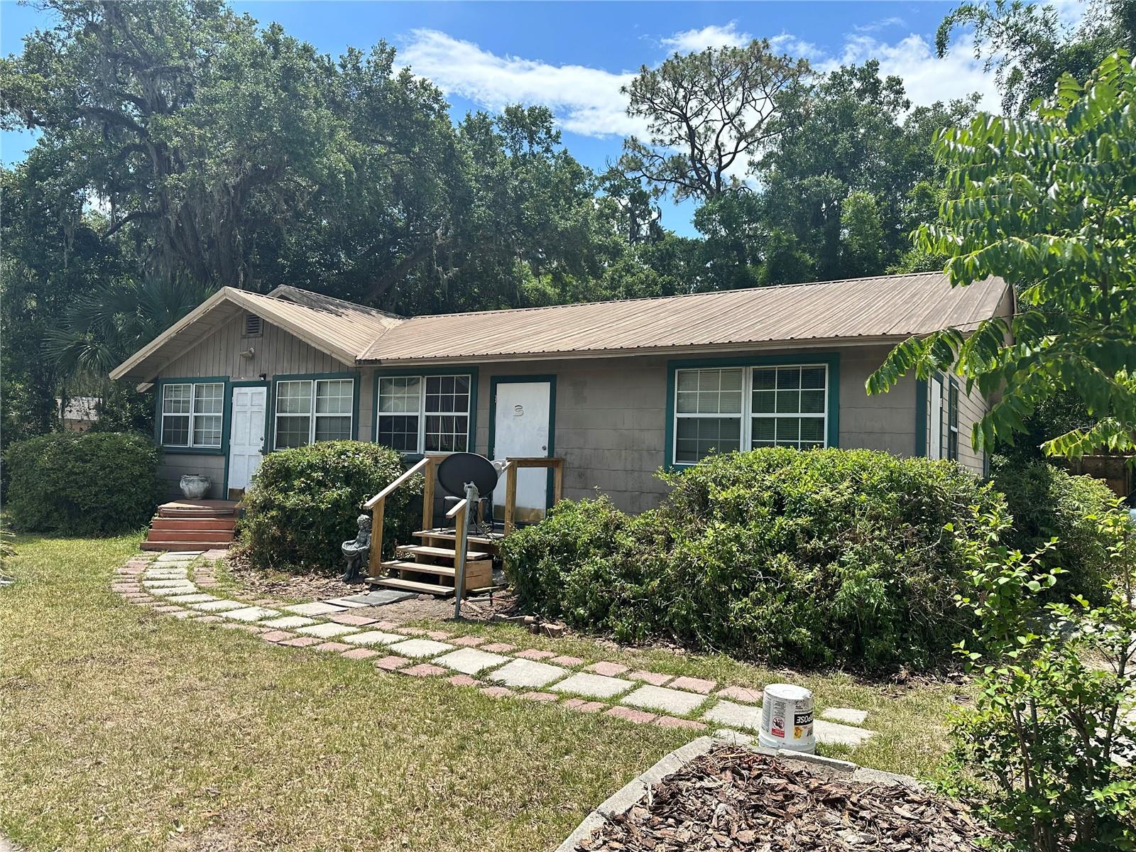 Looking for a solid investment opportunity? Whether looking to add to your real estate portfolio or down size while still living rent free, this property satisfies both possibilities. Six bedrooms could be individually leased for extra income. Complete with some furnishings, including a fully equipped kitchen with 2 refrigerators, washer and dryer, and other appliances. Metal roof updated in 2010, updated 200 amp panel and plumbing throughout the main home. Separate to the main house sits a 1300 sqft one bedroom, one bathroom with a loft unit rented through June 2026 for $1400 per month. This space is also equipped with a functional kitchen and 3 wall mounted ac units, plus a functional workshop.