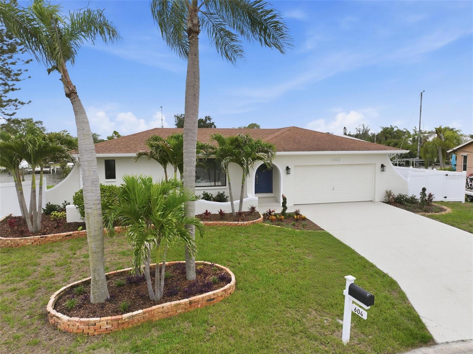 Welcome to this stunning fully renovated waterfront residence in the heart of Apollo Beach, where modern coastal design meets effortless Florida waterfront living. Perfectly positioned on a canal with no bridges to the Gulf, this turnkey home offers an exceptional blend of style, comfort, and boating convenience.

Inside, the home has been thoughtfully redesigned with quality finishes and a bright, open feel throughout. Luxury vinyl plank flooring extends seamlessly across the entire interior, complemented by fresh paint, upgraded baseboards and casing, new interior doors, updated lighting, ceiling fans, and modern plumbing fixtures.

The beautifully redesigned kitchen serves as the centerpiece of the home, featuring premium quartz countertops, soft-close cabinetry, brand-new upgraded LG stainless steel appliances, and a convenient pass-through serving window to the expansive covered lanai — ideal for effortless indoor-outdoor entertaining. The dining room features a custom dry bar with a built-in wine refrigerator, adding an additional touch of luxury and functionality to the space.

The split-bedroom floor plan provides both privacy and functionality, with a spacious primary suite tucked away from the guest bedrooms. Both bathrooms have been completely renovated with new cabinetry, upscale quartz surfaces, and elegant contemporary finishes. Additional upgrades include a brand-new HVAC system and a freshly epoxied garage floor.

Step outside to experience the true Florida waterfront lifestyle. Situated on an oversized pie-shaped lot with approximately 150 feet of water frontage, the property showcases a new seawall, fresh exterior paint, professionally designed landscaping, and lush new sod creating exceptional curb appeal from the moment you arrive. The oversized dock has been freshly stained and includes a separate floating dock, while the newer seawall adds additional value and peace of mind. Multiple sliders and large windows throughout the home invite in natural light and capture beautiful water views, seamlessly connecting the indoor and outdoor living spaces.

With no HOA, direct Gulf access, and every major cosmetic detail already completed, this beautifully updated Apollo Beach waterfront retreat offers a rare opportunity to enjoy luxury coastal living in a truly move-in-ready setting.