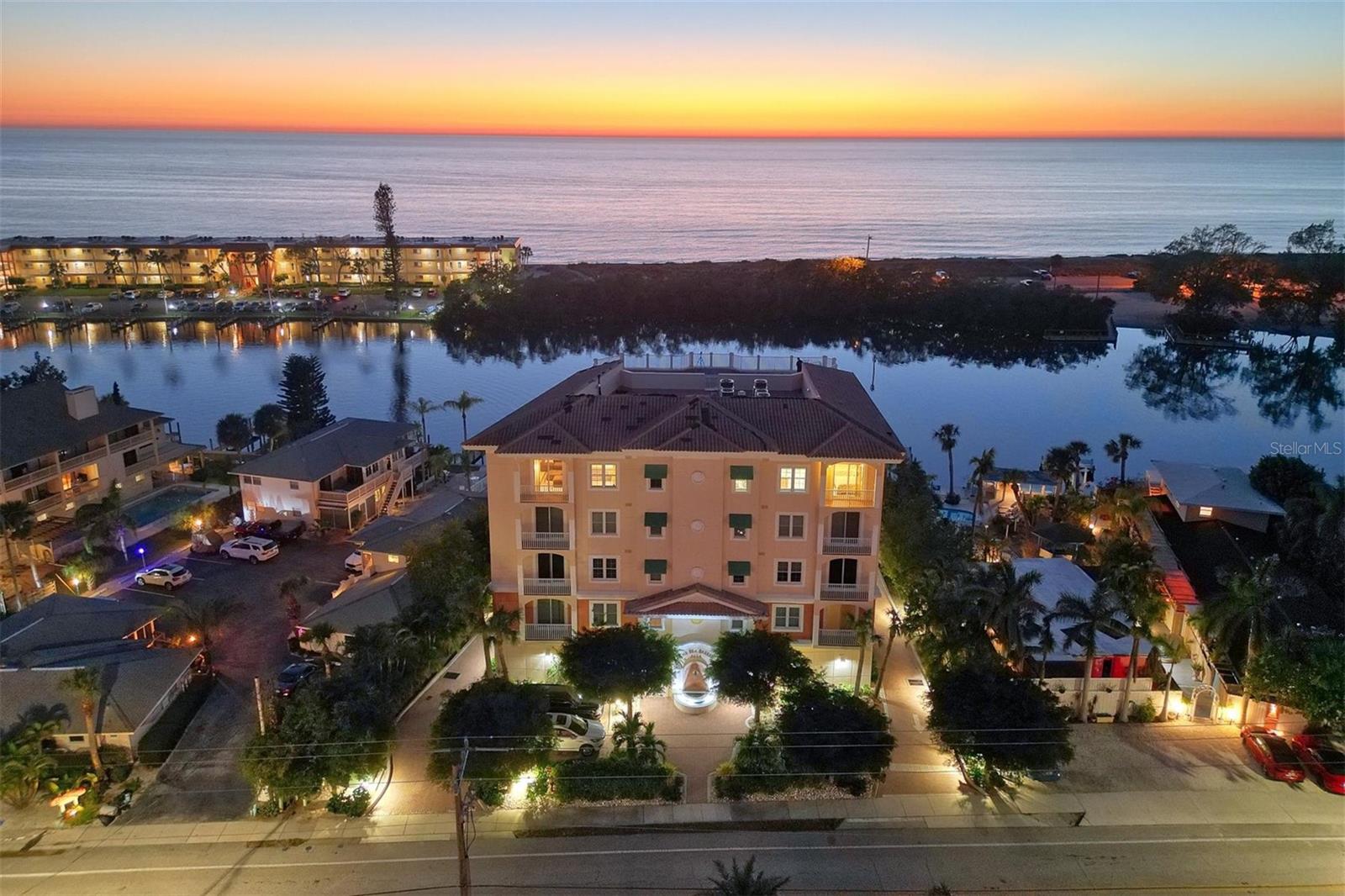 One or more photo(s) has been virtually staged. Seller motivated - asks to bring ALL offers!!!  Have it All….Gulf, Bay, Beach & Boating from this unique full-floor Penthouse with its own private roof-top terrace. Located on Siesta Key where the #1 beach & notable sunsets are talked about world-wide and can be enjoyed from your own 5,675 sq ft condominium home.  Your elevator escorts you directly to your private residence from a deeded under-building oversized 2-car garage large enough for kayaks and assorted water toys. Your boat can be waiting for you from your deeded boat slip. Highlights include 10 ft ceilings, travertine tile floors, KeepSafe hurricane-rated windows & sliders and 2 new A/C units. A chef's kitchen opens to the family room on one side & gathering room on the other side with a breakfast bar & new stainless appliance. For a more formal setting is a dining area with a dramatic oval ceiling. The owner's suite is an expansive 16x25 with a double set of siding doors and forever water & beach views plus easy access to the rooftop terrace for thrilling nightly sunsets. The private guest suites are tucked away with their own en-suite baths & walk-in closets. The Sea Breeze condominium is a boutique size building built in 2004. Amenities include besides a boat slip a waterfront heated pool/spa with poolside seating and is pet friendly. Take advantage of this unique opportunity for a maintenance-free resort lifestyle.