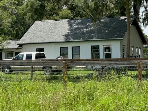 Looking for land with a small home on  25 plus acres that has beautiful trees, existing horse fencing on NE Jacksonville Road.  This listing includes all five parcels and would make a great equestrian or small cattle farm with a lovely 3/1 home and a small carport.  This piece has untold potential and is completely high and dry on a paved road.