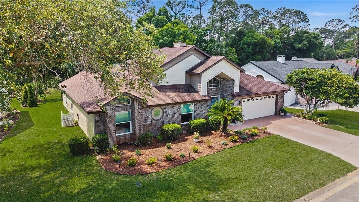 This pool home is located in Breakaway Trails, a sought after gated community. This brick front home features 3 bedrooms, 2 bath, formal living and tiled dining room with a double sided fireplace, a large family room, double doors lead to the large master suite boasting his and her walk-in closets and master bath with a garden tub plus shower and stained-glass window. The kitchen has a lovely breakfast nook in addition to a breakfast bar. All of the rooms in this home are open, light and bright with volume ceilings and large windows, built-ins in the third bedroom. Second bath also has a stained-glass window. Large inside laundry room would accommodate a 1/2 bath addition. Central vacuum system, washer, dryer, oversized garage with built-in cabinets and a two zoned air conditioner All wrapped around screened/heated pool & spa set on a lovely lot with beautiful mature trees and plants. Playground, pickle ball, tennis, basketball and courts are in the community.