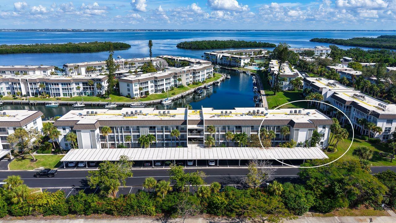 One or more photo(s) has been virtually staged. NEW PRICE IMPROVEMENT! REDUCED $35,000!

NEWLY REMODELED • COASTAL LUXURY RESIDENCE Longboat Harbour • Building E #208 | Corner End Unit • Bay & Harbour Views. CLOSEST BUILDING TO A SHORT WALK ACCROSS THE STREET WITH A PRIVATE DEEDED GULF BEACH ACCESS WITH PAVILION, RESTROOMS AND SHOWERS

TOTALLY REMODELED FROM FLOOR TO CEILING second-floor corner residence in the highly sought-after Longboat Harbour Community. This light-filled home captures sweeping views of Sarasota Bay and Longboat Harbour.
This spacious two-bedroom, two-bath retreat has been transformed with exceptional attention to detail. Elevated finishes, a soothing coastal palette, and an airy open layout blend modern luxury with effortless livability. Corner units of this caliber are rarely available.  From the two bedrooms, you step out to the exceptionally Large Lanai with floor to ceiling sliding glass doors.

A SHOWCASE KITCHEN WITH TWO SUNLIT WINDOWS AND WATER VIEWS Elegant, functional, and beautifully appointed:
• Frigidaire Professional stainless steel appliances • Gleaming quartz countertops • 9-inch deep sink • Pull-out cabinet shelving • Pantry closet • Designer tile backsplash • Large Eat-In Kitchen with water views & sunsets • Instant hot-water.

LUXURIOUS PRIMARY SUITE
An elevated retreat professionally designed for comfort and relaxation • Private ensuite bath • Custom California Closet walk-in wardrobe • Built-in desk feature • Remote-controlled luxury solar shades.

RESORT-INSPIRED AMENITIES
Longboat Harbour offers a lifestyle unmatched on the Gulf Coast:
• Designated covered parking spot conveniently located • Personal storage space on the third floor • Private deeded Gulf beach access with pavilion, restrooms & shower • Four sparkling pools • Fitness center & sauna • Tennis & pickleball courts • Billiards room, library & meeting rooms • Picnic areas with grills • Putting green • Fishing pier • Affordable resident-only boat dockage • KAYAK LAUNCH and KAYAK WHICH SELLER WILL BE GIFTING TO THE BUYER.
Enjoy effortless waterfront living and endless ways to explore the natural beauty of Longboat Key.

PROPERTY ENHANCEMENTS & UPDATES:
Thoughtfully improved for comfort, reliability, and peace of mind:
• NO HURRICANE DAMAGE OR FLOODING
• Bosch Washer & Dryer
• Newer AC: 12/5/21
• Newer Hot Water Heater: 3/3/17
• New roofs throughout the community
• Electrical and plumbing systems updated.
  A BEAUTIFULLY RENOVATED INTERIOR THAT CREATES THE ULTIMATE COASTAL LIFESTYLE/

  THE MONTHLY HOA FEE INCLUDES HAZARD, HURRICANE AND FLOOD INSURANCE/
  RESERVES HAVE BEEN FULLY FUNDED