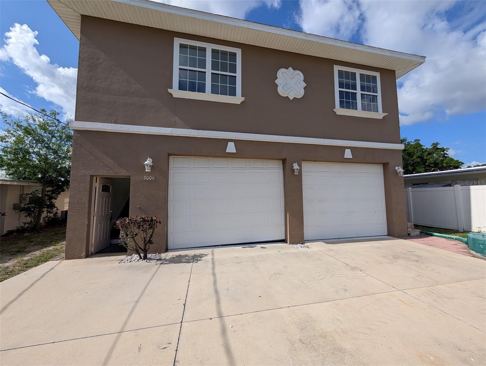 This property is eligible under the Freddie Mac First Look Initiative through 06/20/2026. This home features a 1800 sq ft+ garage (entire first floor). The home is ready for your remodeling ideas! The property is full of potential. You will immediately see the layout’s incredible versatility. The main living area upstairs serves as the heart of the home, featuring a bright kitchen and a spacious living room. Step outside the sliding glass doors onto the second-floor lanai, a great space to enjoy the Florida breeze and overlook your surroundings. The property is located just outside the City of Sarasota (in the county), there are no HOA fees or deed restrictions.