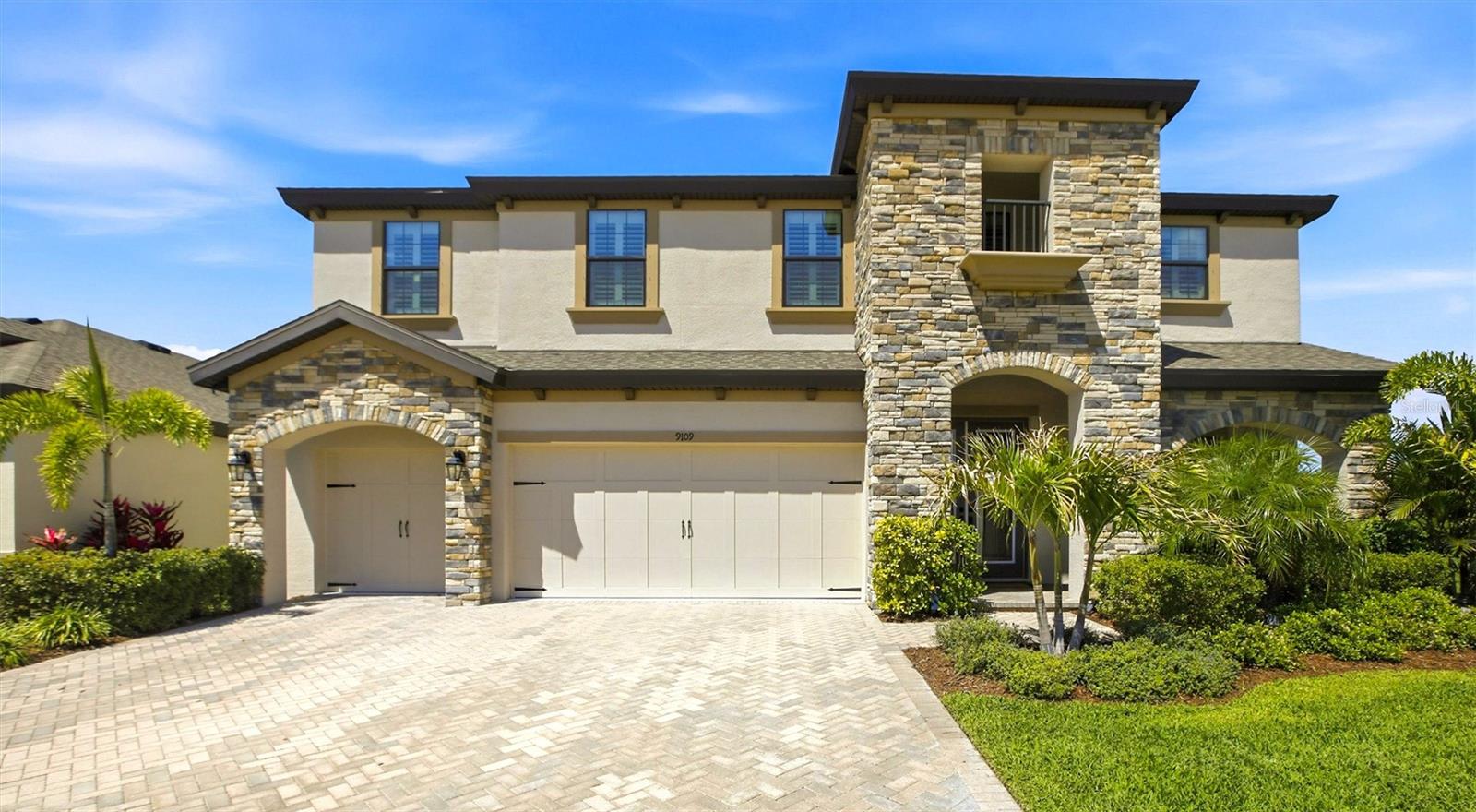 Welcome to this beautifully designed Virginia Park model located in the highly sought-after North River Ranch community. Offering approximately 3,600 square feet of living space, this spacious home features 5 bedrooms, 4 full bathrooms, and a functional open-concept layout ideal for both everyday living and entertaining. Upon entry, you’ll notice high ceilings, abundant natural light, and luxury plank flooring throughout the main living areas. A separate dining space is positioned just inside the front entry, providing flexibility for formal dining or additional living use. The gourmet kitchen is centrally located and well-appointed with quartz countertops, upgraded cabinetry, stainless steel appliances, a large center island including extended built-in kitchen table with seating, and a walk-in pantry. The kitchen opens to the main living area, creating a seamless flow for gatherings. The first floor includes a bedroom with a walk-in closet and a full bathroom, offering a convenient option for guests or multi-generational living. Additional features include a 3-car garage (two-door configuration) providing ample space for vehicles and storage. Upstairs, the primary suite offers a spacious retreat with an en-suite bathroom featuring a glass-enclosed shower, soaking tub, dual vanities, and an oversized walk-in closet. The second floor also includes three additional bedrooms and a large loft/bonus area, ideal for a media room, playroom, or home office. Sliding glass doors lead to a private backyard with maintained landscaping, providing outdoor space to relax or entertain. Conveniently located near shopping, dining, schools, and major roadways, and just a short drive to Gulf Coast beaches, this home offers a balance of space, functionality, and location within a growing master-planned community.