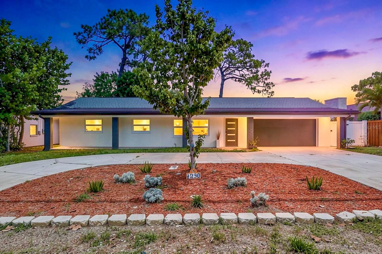 Come see this beautifully REMODELED/UPDATED 4BR/3BA home offering 1,869 sq. ft. of MODERN living in one of Dunedin’s most desirable GOLF CART friendly communities! Located in Flood Zone X – high and dry! NEW ROOF 2025, NEW ENERGY-EFFICIENT WINDOWS AND SLIDING GLASS DOORS 2025, A/C 2017, NEW WATER HEATER 2025, NEW FRONT DOOR 2025, newer GARAGE DOOR (2017), upgraded 200 AMP electrical panel (2013), and no water or storm damage from recent hurricanes. NO HOA or CDD fees!
The home features an open-concept kitchen and living room with large new energy-efficient windows that bring in an abundance of natural light throughout the space. The fully renovated kitchen offers a large island, under-cabinet lighting, pendant lights, stainless steel appliances, and sleek modern finishes perfect for entertaining. Luxury vinyl flooring flows throughout the entire home, complemented by modern lighting fixtures and beautifully remodeled bathrooms with tile extending all the way to the ceiling for a clean, upscale look. There is also a spacious dining area surrounded by large windows and sliding glass doors leading to the backyard, creating seamless indoor-outdoor living. One unique feature of this home is the 4th bedroom, which can easily be used as a primary bedroom or a mother-in-law suite thanks to its private entrance, en-suite bathroom, and two walk-in closets. This versatile space could also make a great family room, as it features a cozy fireplace - making it the perfect flex space that can be anything you want it to be.. The home also offers a 2-car garage with an additional 3rd bathroom and a spacious laundry room with extra space for storage. Outside, enjoy the fully fenced backyard, pergola, a shed, and convenient circular driveway making it easy to come and go. This home is just minutes from charming downtown Dunedin with its local restaurants, breweries, boutiques, festivals, marina, and the famous Pinellas Trail. You are also only about 10–15 minutes from the beautiful beaches at Honeymoon Island State Park and the scenic Caladesi Island State Park, known for their crystal-clear Gulf waters, kayaking, nature trails, and stunning sunsets. Nearby parks like Hammock Park and Highlander Park add even more outdoor recreation options, while easy access to Clearwater, Palm Harbor, and Tampa makes commuting and entertainment convenient. This MOVE-IN READY home offers the ideal combination of modern upgrades, prime location, and Florida lifestyle living. Schedule your showing today!