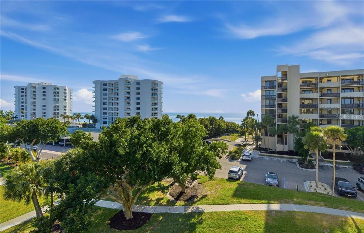 Virtually Staged. A vivid palette of white perfected with the backdrop of crystal sand meets azure Gulf blue….. finished off with brilliant hues over the spanning skies as the sun sets on yet another perfect day.  Yours to be experienced daily, from the inside or out on the patios, at this corner condo home spread over more than 1,800 square feet.  Well-positioned at the southwest corner of Building 10 to take full advantage of what it means to be the fortunate owner of a beachfront Longboat Key retreat.  Clean, crisp and white, this home is move-in ready, OR it is fresh and primed for you to begin the design of your dreams.  Finding 3 bedrooms, 2 baths, and 2 owned parking spaces (one under-building and one outside steps to the building entry) on the beach at this reasonable price point is a FIND in this zip code, so closely consider the opportunity at hand.  Beachplace is a sprawling community of 31 acres and full of amenities including, but not limited to, deeded beach access, junior Olympic size pool, kiddie pool, spa, clubhouse, fitness, tennis, pickleball, guarded/ gated entry, community grilling, fun gaming area with ping pong, cornhole, seasonal community activity calendar, etc.  Truly a special place to call home or an absolute escape to refresh, restore, relax, release and renew the wellbeing of mind, body and spirit.