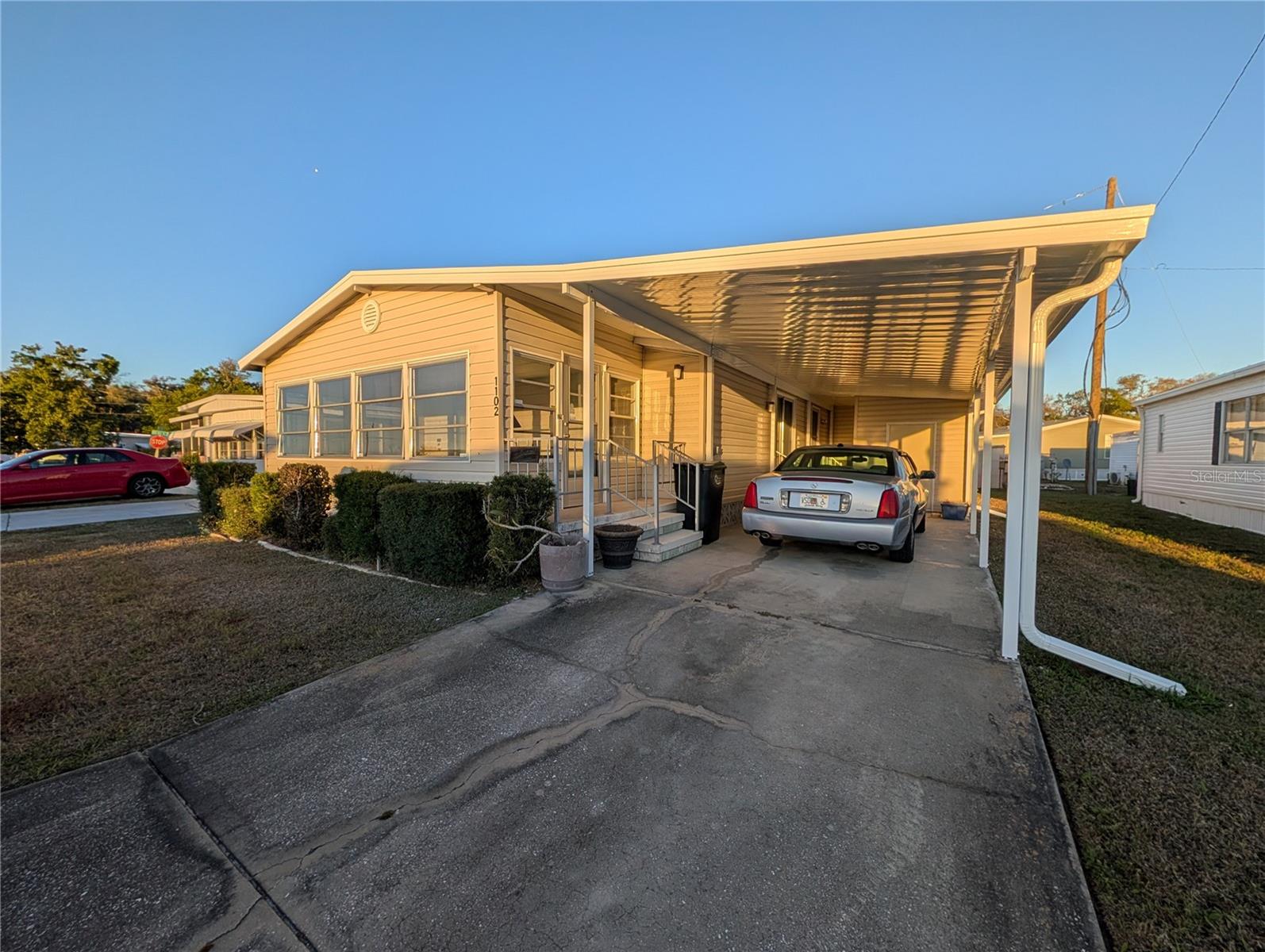 Discover the potential in this spacious 3-bedroom, 2-bath manufactured home located in the desirable 55+ land-owned community of Tidevue Estates in Ellenton, Florida. With a little TLC, this charming home can easily become your ideal Florida retreat. Step inside to find a generous living room that offers plenty of space for relaxing or entertaining guests. The home also features a bright and inviting sunroom—perfect for enjoying your morning coffee, reading a book, or soaking in the beautiful Florida sunshine year-round. The updated kitchen provides ample cabinet space and storage, making meal prep and organization a breeze. An inside laundry room adds everyday convenience, keeping everything easily accessible. Outside, the covered carport leads to a large utility room that offers excellent weather-protected storage or the perfect space for hobbies, tools, or a workshop. Tidevue Estates is a golf-cart friendly neighborhood with a  community center with indoor pickleball and a pool.  This is a no pet community and HOA application and approval are required for purchase.