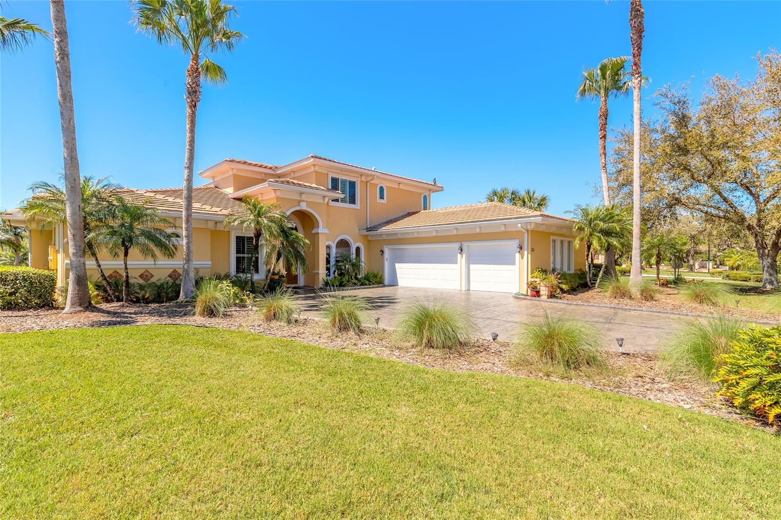 Opportunity awaits for the new owner of this sprawling LPGA Estate backing onto the world-class golf course. Every time you return home, it will feel like arriving at a luxury resort. The Mediterranean style is evident in the tile roof, gorgeous archway openings, and stamped-stone private driveway. The three-car garage offers extra parking for your golf cart or an additional vehicle.

Upon entering, you will immediately notice all of the high-end finishes that have been added to the property. There is room for all with five bedrooms and four bathrooms, offering nearly 3,700 sq. ft. of living space. The spacious owner's suite is located on the main floor and boasts a beautifully updated bathroom with a soaking tub and two walk-in closets with custom-built, lighted cabinetry. All bathrooms have been upgraded with electronic smart toilets featuring bidets.

Entertaining friends and family is a pleasure with the open-concept, recently renovated chef’s kitchen and family room that opens up to the covered lanai and pool deck through newly replaced sliding glass doors. Enjoy the beautiful Florida weather on your sun-filled pool deck overlooking the golf green while preparing food in your outdoor kitchen. Relax in the hot tub while you enjoy the sunset.

The extra-deep lot provides additional green space beyond the pool deck for you to enjoy. A whole-house generator provides peace of mind during power outages. Located on one of the most prestigious streets in LPGA, this property is sure to please.