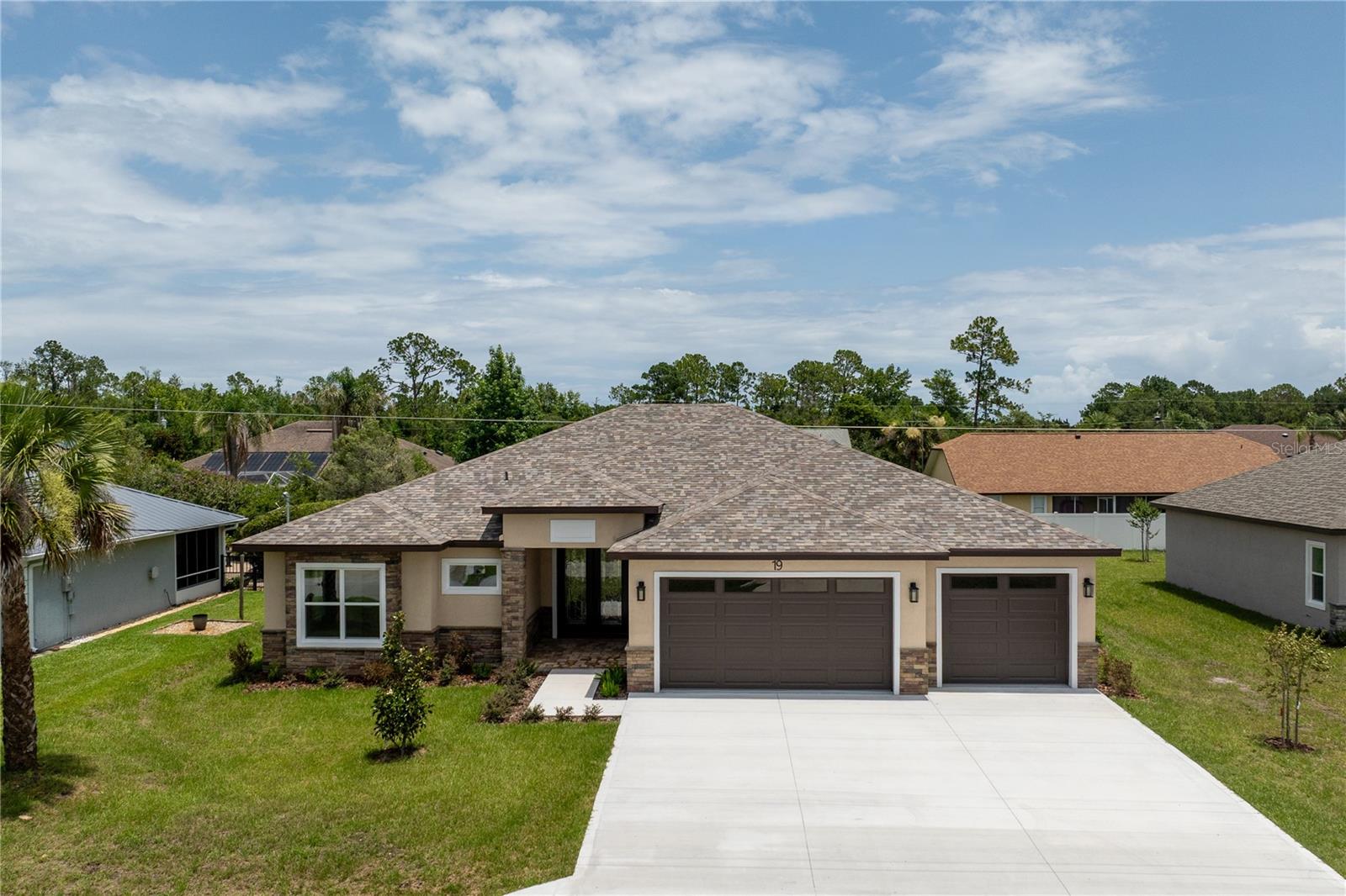 Beautifully designed 4-bedroom, 3-bath home with a spacious 3-car garage featuring a thoughtfully designed open-concept floor plan that blends comfort, functionality, and modern living. The expansive kitchen offers a large center island, abundant cabinetry, stainless steel appliances, and generous workspace, flowing seamlessly into the inviting living area with an elegant tray ceiling and spacious dining area—perfect for everyday living and entertaining. The private primary suite features a tray ceiling, a spacious walk-in closet, and a beautifully appointed en-suite bath, while three additional bedrooms provide flexibility for family, guests, or a dedicated home office. Additional highlights include an indoor laundry room, pull-down attic access, contemporary lighting, and quality finishes throughout. Enjoy the freedom of no HOA fees. Conveniently located in an established neighborhood surrounded by scenic freshwater canals, just minutes from Flagler Beach, parks, walking and biking trails, shopping, dining, and everyday conveniences, this home offers the perfect combination of comfort, convenience, and the Florida lifestyle.