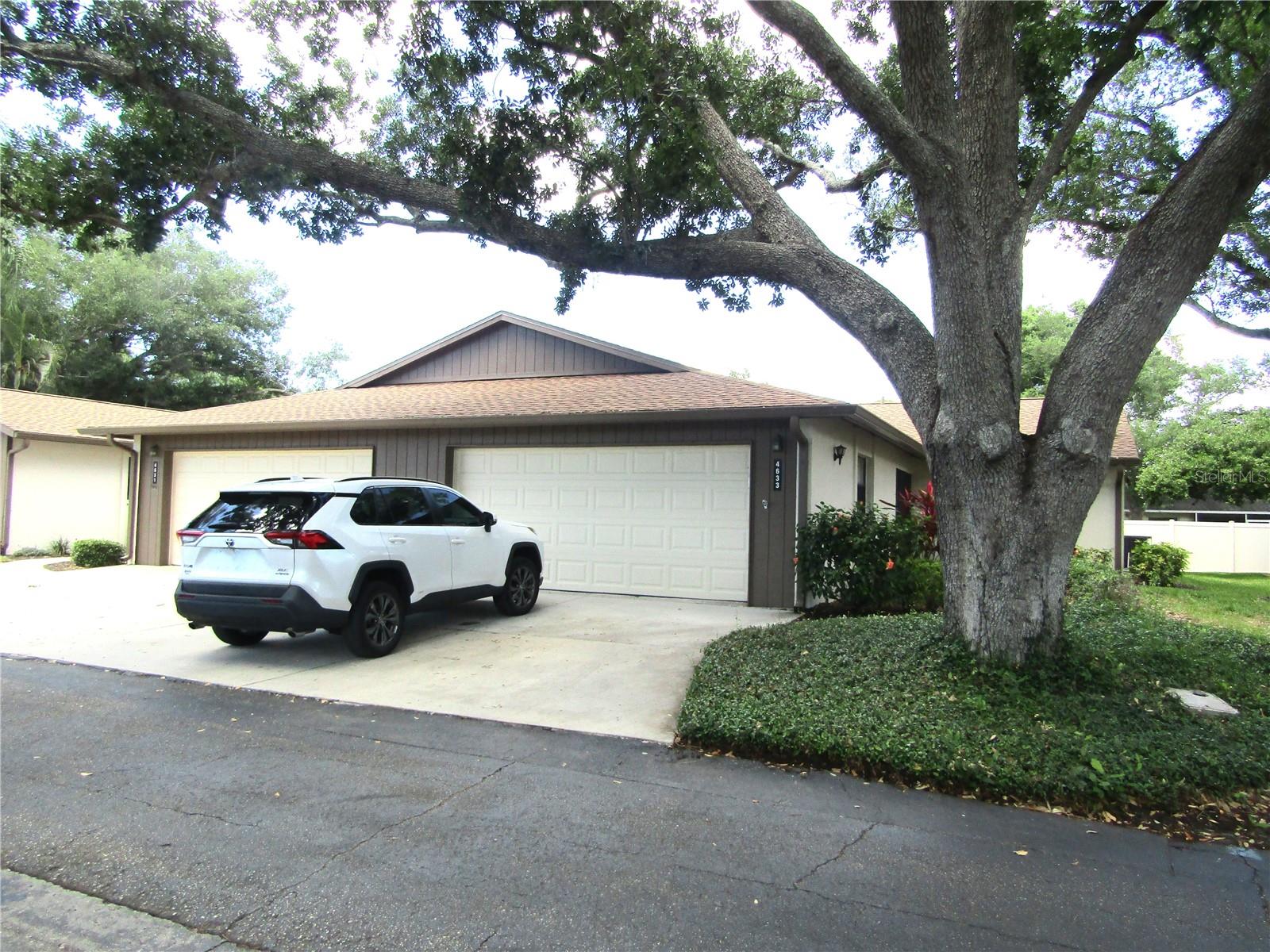 Centrally located and nestle amongst lush foliage and stately oaks this 2 bedroom 2 bath villa is ready to call your new home.  Updated kitchen with newer appliances and laminate flooring are just a few of the upgrades you will find in this spacious villa.  The master bath boasts a beautifully remastered walk-in-shower with optional hand held shower head as well as grab bars for handicap accessibility.  The vaulted living ceilings adds to the spacious feeling of this home.  The enclosed lanai offers additional living space and would be a perfect spot to set up your office.  The exterior of the property has a new roof, new garage door, new gutters and is maintained by the Association.  Village Oaks is an active community with tennis & pickleball courts, a lakeside pool and park. Just minutes away from downtown Sarasota, The UTC Mall, Benderson Rowing facility and many options for dining and shopping.  Property is sold  "As Is" please use an "As Is" contract, please provide proof of funds or pre-approval letter. Room measurements are approximates and should be verified by the buyer.