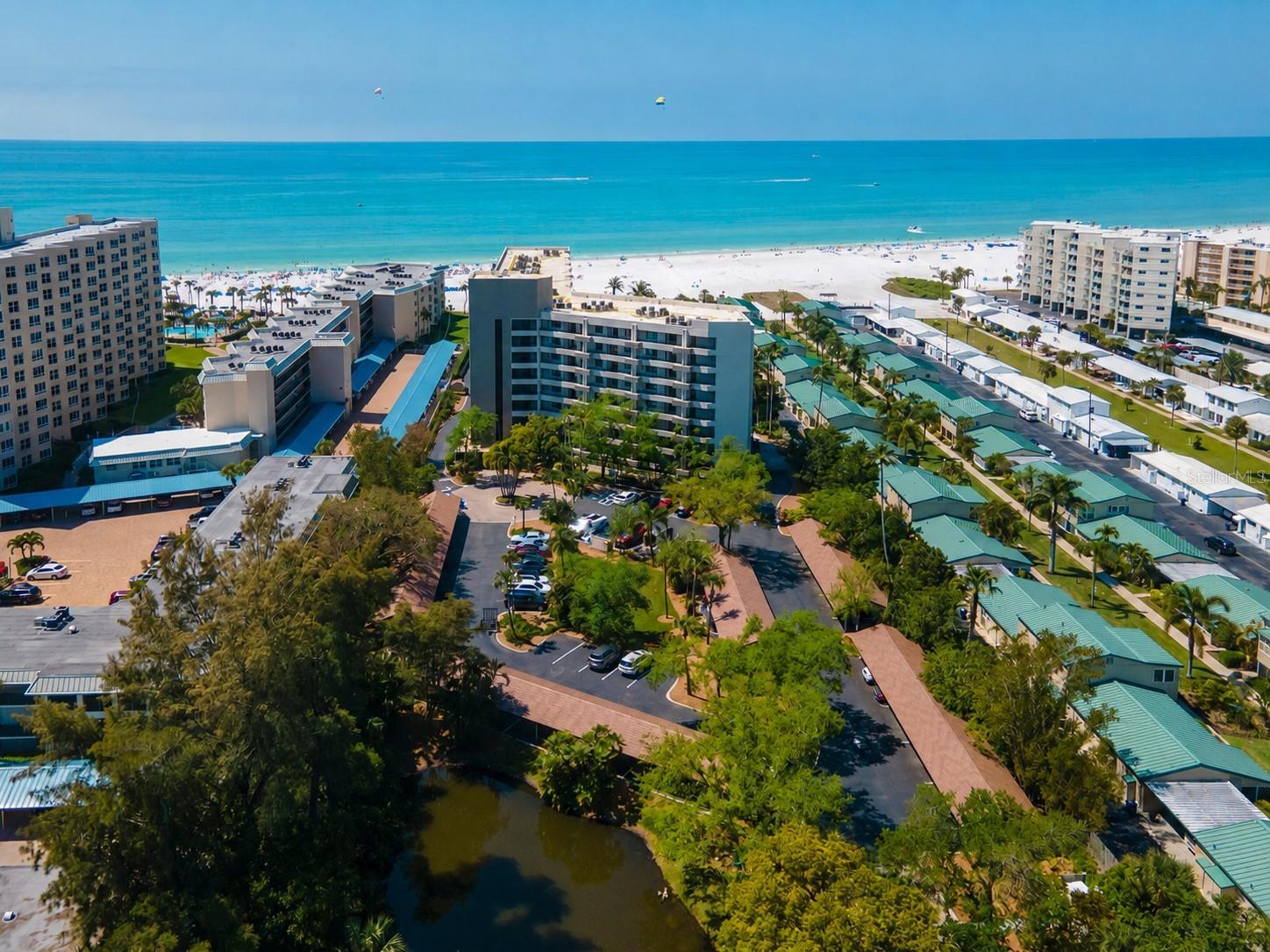 The least expensive unit in the sought-after Casarina on Siesta Key with another price reduction of $50,000! This Top-floor unit offers stunning views of Siesta Beach and all the comforts of home.  The interior has been tastefully updated with modern finishes and stylish decor. The unit is being sold furnished (minus few staging items). The kitchen has newer cabinets and upgraded appliances. Enjoy the spaciousness of the living/dining combination area and be drawn to the expansiveness of the enclosed patio where you can enjoy evening sunsets.  The 17-by-12-foot primary bedroom has luxury vinyl flooring and room for a small desk area. The primary bath has new vanities, mirrors and lighting.  Casarina has seven acres of newly planted tropical landscaping and 200 feet of private beach. The main lobby has recently been updated. Spend your days swimming in the heated pool, soaking in the spa, playing tennis, pickleball, basketball or simply enjoying the quiet beauty of the #1 Siesta Key Beach. With covered parking, a secure lobby and an on-site manager, everything you need is right here. Enjoy being close to the shops and restaurants of Siesta Village and only minutes from downtown Sarasota’s arts, dining and world-class healthcare. This is your chance to own and live in beautiful Sarasota. Owner has paid all the present assessments for the new upgrades to the property and building.