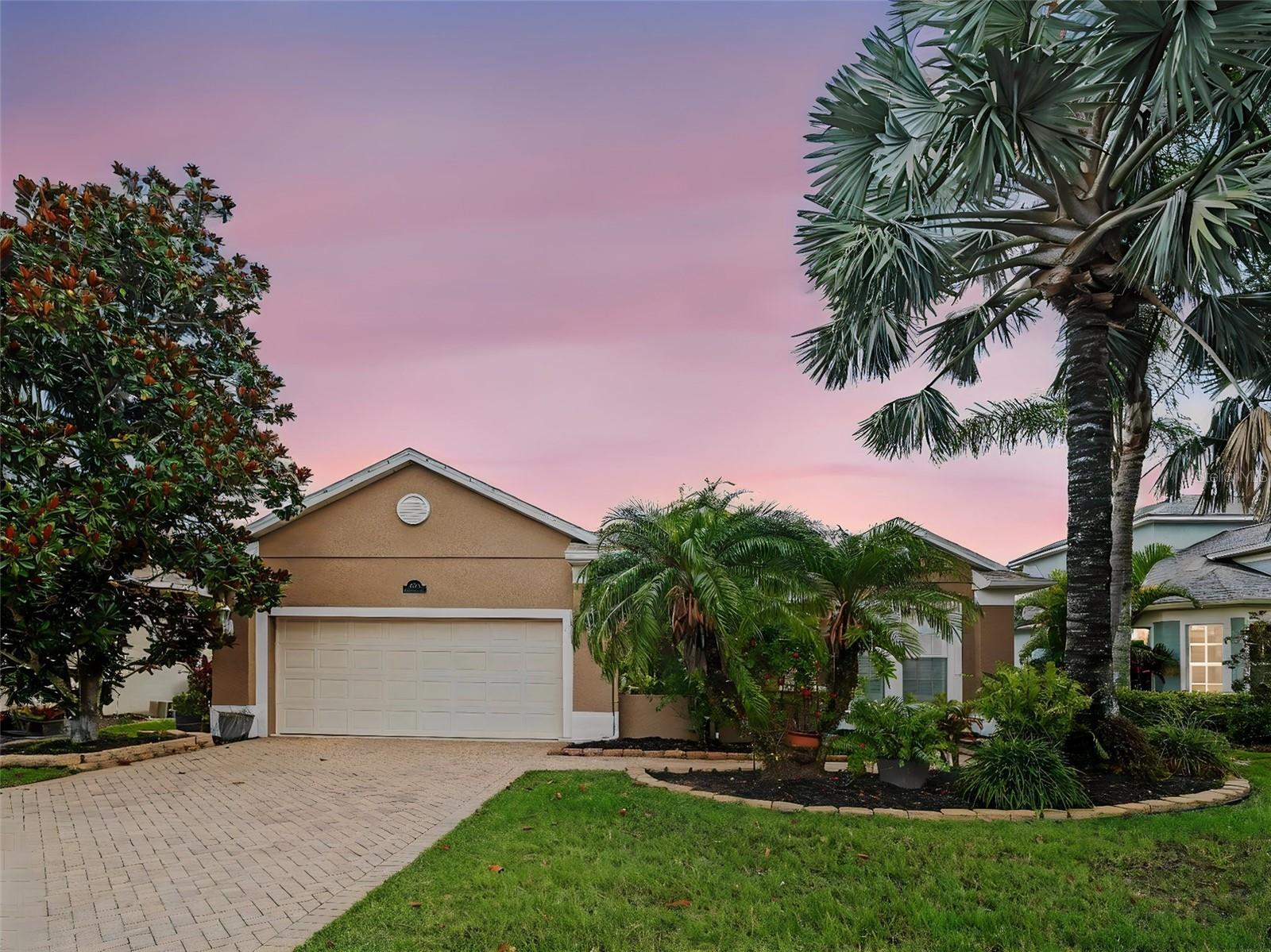 One or more photo(s) has been virtually staged. Serene lake views, a private pool and spa, and timeless craftsmanship — this Sam Rogers-built Greyhawk Landing home delivers the Florida lifestyle from every angle. Offering 3 bedrooms, a dedicated den, and 2 bathrooms across 2,276 square feet, this beautifully designed residence showcases thoughtful finishes and refined architectural details throughout — plus the added peace of mind of a newer roof and water heater, and the rare advantage of Flood Zone X designation, meaning no flood insurance is required.
Inside, the open great-room floor plan features a separate formal dining area enhanced by volume ceilings, crown molding, diagonal-set neutral tile, plantation shutters, and custom designer paint. Newly installed modern wood flooring runs throughout all three bedrooms, and the gourmet kitchen is appointed with granite countertops, stainless steel appliances, and freshly painted cabinetry. Both bathrooms have been updated to reflect the same clean, modern aesthetic carried throughout the home.
The primary suite enjoys tranquil lake views, dual walk-in closets, and a spacious five-piece bath with a soaking tub and separate shower. A split-bedroom layout ensures privacy for family and guests, while the den also captures peaceful water views.
The screened lanai extends the living space outdoors, overlooking the pool, spa, and serene lake beyond. Recent exterior improvements include a professionally power-washed, sanded, and sealed driveway, walkway, and front brick areas — enhancing both curb appeal and long-term maintenance value.
 Located within Grayhawk Landing, a gated 960-acre community surrounded by lakes and natural preserves, residents enjoy more than five miles of walking and biking trails along with resort-style amenities including multiple clubhouses, swimming pools with waterslides, spa facilities, tennis and pickleball courts, basketball courts, a fitness center, playgrounds, and soccer fields. Conveniently situated just east of I-75 and close to highly rated schools, shopping, and dining, this home offers an exceptional blend of comfort, convenience, and Florida lakefront living.