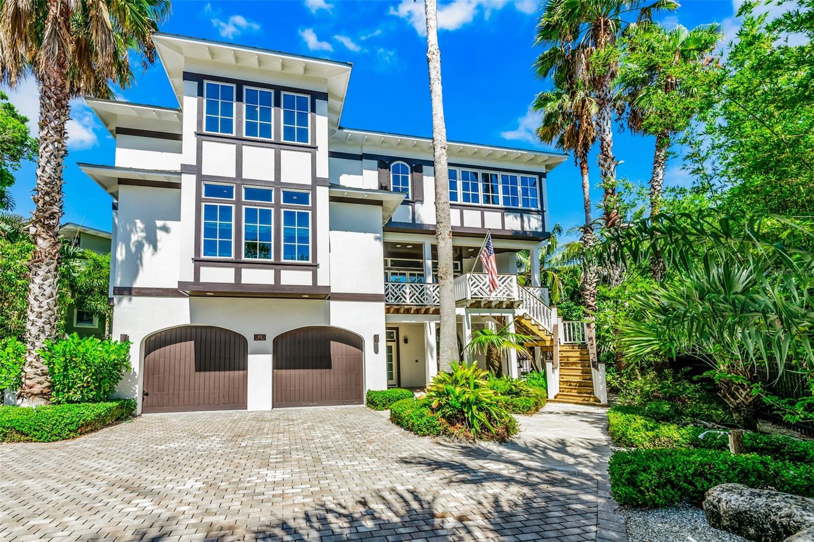 LUXURY COASTAL LIVING AT IT’S FINEST! This one-of-a-kind residence, designed by Emily Anne Smith, stands on one of the most sought-after streets in Anna Maria, just one home from the Gulf and a short walk to the charm of Pine Avenue. The location offers an exceptional combination of beach proximity, walkability, and privacy.
Thoughtfully designed for both entertaining and multi-generational living, the home offers over 4,500 square feet of curated living space with distinct gathering areas throughout. The main living room opens to a front verandah and features a fireplace, with an additional fireplace located in the primary suite.
The kitchen, designed for both function and presentation, featuring marble countertops and backsplash, custom cabinetry, a butler’s pantry, and dual sinks is well-suited for both everyday use and larger gatherings.
Emily Anne Smith is known for her mindful and timeless coastal design, and this home reflects that level of craftsmanship throughout.
The property includes a main residence and a separate cottage, providing flexibility and privacy with a total of 5 bedrooms and 4.5 bathrooms. Additional features include multiple verandahs, two dedicated study spaces, and a well-designed outdoor living area with a pool, shower, and lounge space.
The private guest quarters with separate entrance offers an ideal setup for extended family, guests, or private accommodation.
This is a rare opportunity to own a thoughtfully designed home in a premier Anna Maria location, with Gulf views and exceptional sunset exposure.