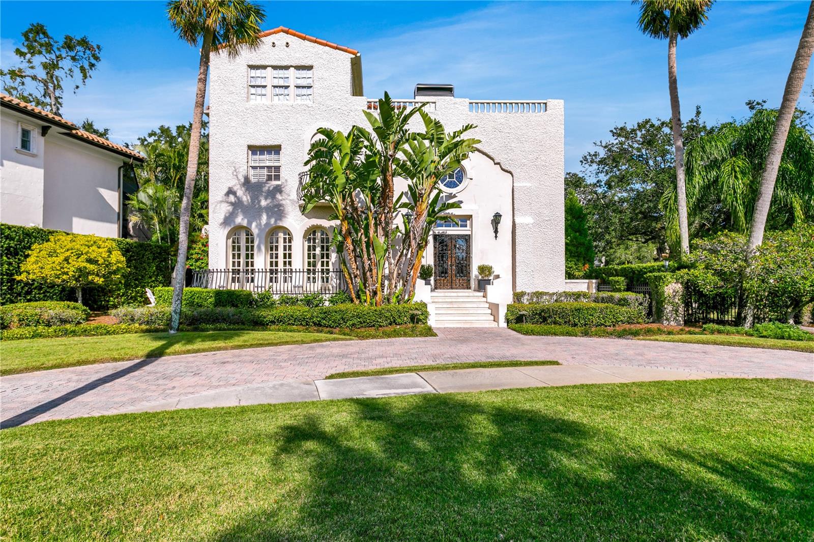 Welcome to this esteemed estate along Bayside Drive, where you’ll instantly feel as if you are stepping back in time to the fabled days of grand living along Tampa Bay’s iconic waterfront. A true reflection of days gone by, combined with modern updating, provides the perfect blend of flair and function in this stately home. Stepping through the gated front entry, you’ll immediately be drawn to the details that have delighted for more than a century. The dramatic vaulted living room with thick arched plaster doorways, Juliet balconies, and soaring coffered ceiling lure you in with drama and elegance. The stunning dining room is adorned with six sets of arched French doors with exterior views of Tampa Bay and an original plaster chandelier medallion that is a work of art. The sunroom invites natural light through arched windows to illuminate herringbone wood floors and provide views of the pool and grounds. The home’s finer details have only been improved upon with updated finishes that include wide plank hardwood floors, marble counters, and high end appliances. All rooms on the first floor are filled with natural light and flow effortlessly when entertaining. The kitchen is equipped for the most discerning chef and opens to the cozy TV area which features a pair of 6ft tall built-in wine fridges. Two stairwells lead you to the second floor where you will find the theater room complete with leather comfort seating for eight, three guest rooms, two baths, oversized laundry and spacious storage room. The main staircase then leads to the primary suite that encompasses the entire third floor. The updated bath includes marble finishes, a deep soaking tub, and glass-enclosed shower, while the dressing room offers an abundance of closet space. Just off the bedroom, you’ll find what may be your favorite part of the home…the private
observation deck with captivating views of the Tampa Bay. The home’s exterior is Gatsby-like with a pool and spa that is set perfectly, providing both privacy and cover, as well as a sunlit deck that wraps the property. The oversized corner lot allows you to enjoy the outdoor space without feeling the intrusion of neighboring properties. Bayside Drive is one of South Tampa’s most beautiful and highly sought after streets for both the quiet privacy and the water access that is afforded to homeowners. This estate comes with a dock and 10,000 lb boat lift, allowing direct access to the open waters of Tampa Bay. While this architectural gem is one of Beach Park’s original grand homes, it is at a higher elevation than other classic properties of its period. The charm of this home will captivate and delight you from first glance until the moment you call it your own.