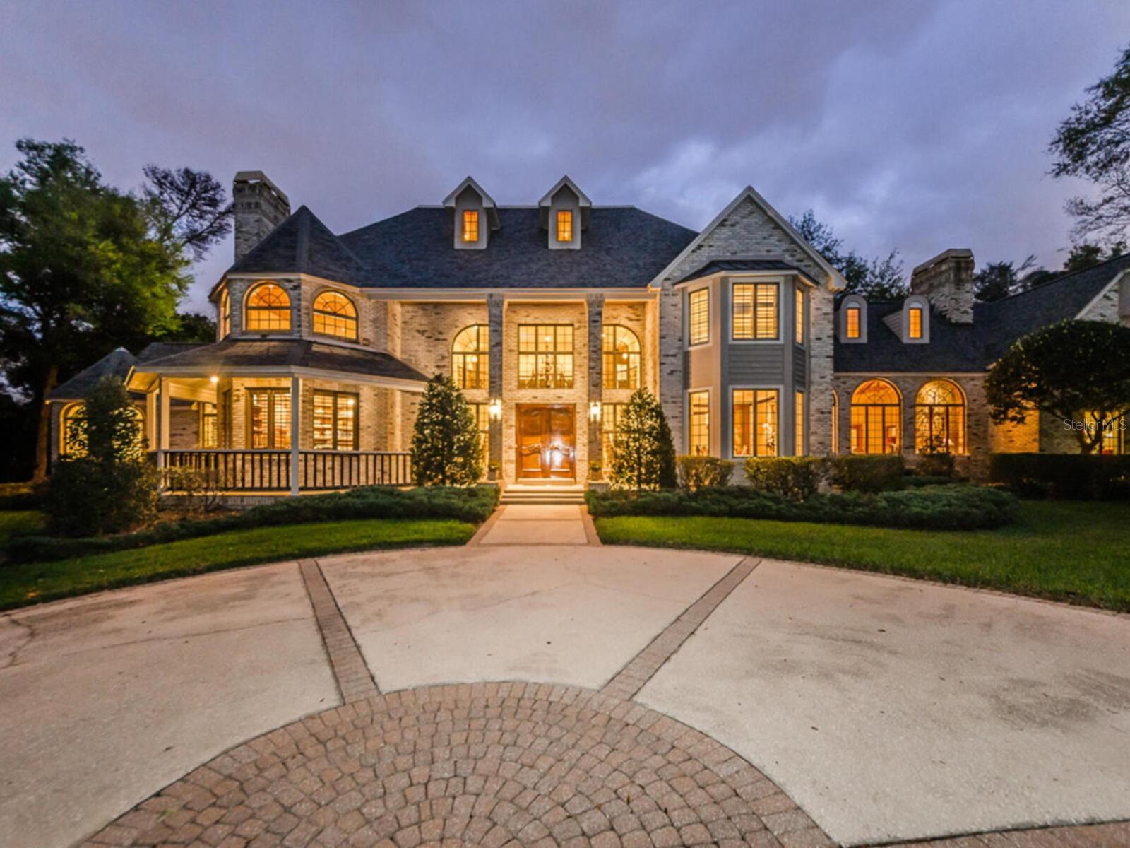 Preview this beautiful home by video at the following link: https://shorturl.at/xtUXD
MAGNIFICENT GRANDEUR AND LUXURY.  Towering trees and lush landscaping graced by a long sweeping concrete drive and Private Gated Entry is the ideal Welcome to this Extraordinary Estate on nearly 2.5 acres.  Country feel yet minutes to shopping and dining. Experience the custom interior of over 6100 sq.ft. designed with world class craftmanship, elaborate detail, elegant finishes and amenities, plus over 1000 sq.ft in the Guest Home.  Light filled living spaces with high ceilings and abundance of natural light. Beautiful Chef's Kitchen for creating all your culinary delights and includes Viking Gas range and Griddle cooktop, Bosch Dishwasher, and Sub-zero Refrigerator. Breakfast Room overlooks patios, pool and treed acreage. Stunning Library with Fireplace and elegant custom designed hardwood built-ins.  Upper level Media Room, or Quest Quarters with Kitchenette and full bath. Magnificent Master Suite with separate sitting room and fireplace overlooking picturesque gardens, waterfall, and pool.  Spacious Master Bath with His and Her separate custom designed walk-in closets, walk-in glass enclosed shower, and   separate stand alone tub.  Newer professional Work-out center and Gym with its own mini hair salon area.  Walk through the lighted gardens and pool patio  to the Guest Home with over 1000 sq.ft. featuring 2 bedrooms, bath, full kitchen, living room, dining room and sunroom with 1 Car Ac garage and its own private pavered patio and garden area.  For the CAR ENTHUSIAST, 2 car garage attached to the main home, 5 car sep. garage building with 3 of the garages converted to an airconditioned Workout Center/Gym and Hair Salon area. 1 car AC garage attached to the Guest Home., Newly painted , Newer premium leaf filter gutters on main home and Guest Home, Newer AC"s, New pool pumps, New irrigation systems, New Pool Deck, and Newer bath renovations. New electrical on well pump.  Private secluded pool and terrace area is ideal for entertaining and comfortable living.  Massive family room with Brick fireplace , wood mantle and built-ins.  Plenty of room for the pool table.   Enjoy the walk-in Bar overlooking the screen enclosed patio area.  Formal Living Room and Entry Foyer with Marble floors and double formal wood staircase and balcony.  Treat yourself to your favorite coffee, latte or expresso in the Coffee Bar off the kitchen. Formal Dining Room with Wood Floors.     This property has plenty of room for your own tennis court, or pickleball court and more.  Secluded and private.  Fenced yard.  Total renovations in 2010 through 2011  the main home and Guest Home.  The 7 bedrooms and baths include the Guest Home bedrooms and Bath. Additional upgrades and features include .Customed designed Wood Moldings around Windows, Arched doorways, and all doors.  8 inch designed Baseboards.  Lots of SPACE, SECLUSION, AND TOTAL PRIVACY.