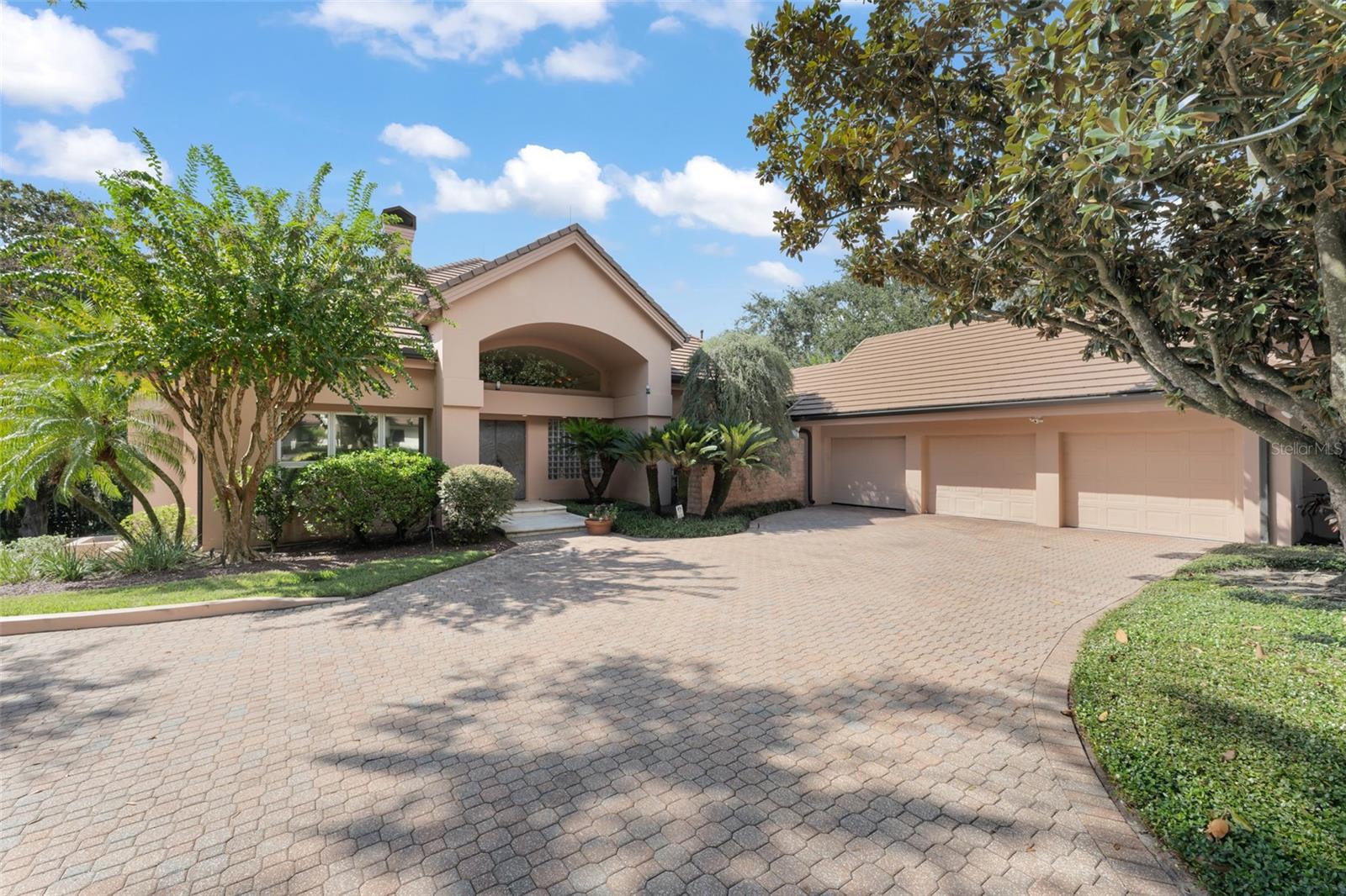 Under contract-accepting backup offers. Within the gates of the renowned Isleworth Golf & Country Club, this beautiful lakefront estate captures the essence of timeless luxury and gracious living. Poised on the shores of Lake Bessie, the 5,548 square-foot residence unfolds across two levels, designed to frame sweeping water views and create effortless spaces for both grand entertaining and quiet retreat. The upper level greets guests with custom French entry doors that flow into the open formal living and dining rooms, perfectly designed for gatherings. The kitchen is spacious and inviting, offering casual dining and seamless access to the main living areas. A richly appointed library adds warmth and refinement, while two en-suite bedrooms complete this floor, including the primary suite. With its oversized windows capturing endless lake vistas, a large sitting area, exterior balcony, and an en-suite bath featuring dual vanities, a soaking tub, and walk-in shower, the primary suite is a sanctuary of light and serenity. On the lower level, the estate offers two expansive bonus areas joined by a well-equipped kitchenette. Ideal for gaming, entertaining, or working from home, both spaces connect effortlessly to the sun-drenched pool terrace—seamlessly integrating indoor luxury and outdoor living. A stunning mature oak tree anchors the property's beautiful lakefront grounds, stretching gracefully toward the water’s edge—a signature of the property’s natural beauty. Beyond the oak tree, Lake Bessie shimmers in full view, offering a breathtaking backdrop to the estate. A rare combination of elegance, versatility, and iconic setting, this residence presents a lifestyle within one of Central Florida's finest communities.