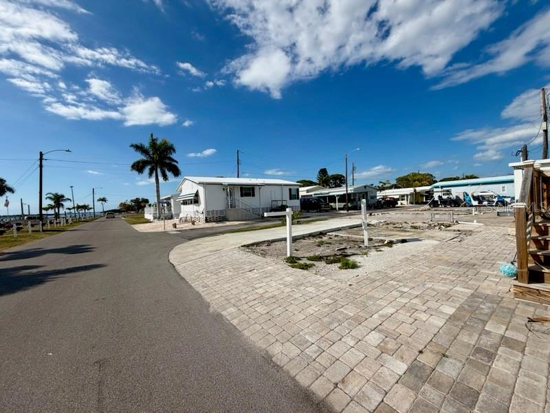 Vacant lot in Paradise Bay Estates. MUST be sold with lot 2-4 (MLS A4670972). Will not be sold separately. Design plans available for a lovely 2BR/2BA new elevated structure that will showcase the beautiful Sarasota Bay waterfront views from this location. Both lots need to be purchased together in order to accommodate a new structure. This rare opportunity to create a new home with outstanding unobstructed  views of Sarasota Bay would allow your retirement dream home to be nestled within the peaceful and vibrant +55 Paradise Bay Estates co-op community. This location offers an unparalleled view of the serene Sarasota Bay.

You’ll be just a short 2-mile walk, bike, drive, or boat ride away from the picturesque beaches of Anna Maria Island, where you can soak up the sun, swim, or explore the island’s charming shops and restaurants.

The community itself is a haven for those seeking both tranquility and excitement. Enjoy a wealth of activities, from musical events and potluck dinners in the active clubhouse to leisurely afternoons at the water’s edge. The park also features several charming gazebos, perfect for watching breathtaking sunsets over the bay or sharing good times with friends.

For boating enthusiasts, there’s a community boat ramp and docks available, though the docks are currently on a waiting list. Kayaking excursions and golf outings are popular pastimes, offering a balance of adventure and relaxation right at your doorstep.

Whether you’re looking to build a peaceful retreat or a vibrant home surrounded by an engaged community, this lot offers an exceptional opportunity to live in a location that truly lives up to its name—Paradise Bay.

Buyer is responsible to do their due diligence with Manatee County and the park to obtain approval to build their chosen structure on these two lots.