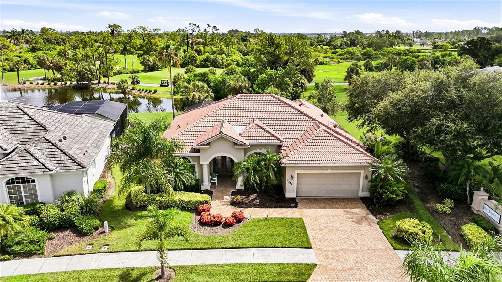 Welcome to HERON CREEK GOLF & COUNTRY CLUB'S newest offering "PALM VISTA!" Sparkling heated pool and spa... tranquil lake views... lush emerald golf greens... and the Florida lifestyle you've been dreaming of! Ideally located just a short golf cart ride from Heron Creek's magnificent clubhouse and resort-style amenities, this well maintained 3 Bedroom, 2 Bath residence welcomes you with a new tile roof (2024), handsome paver driveway, lush tropical landscaping and an expansive paver lanai designed for relaxing and entertaining alike. Inside, soaring ceilings, a sophisticated neutral gray palette, classic plantation shutters and abundant natural light create an inviting atmosphere that feels both casually elegant and effortlessly comfortable. Then comes the home's unforgettable "Wall-to-Wow!" moment as spectacular 45-degree disappearing corner sliders vanish from sight, seamlessly blending the great room with a generous covered lanai, sparkling heated pool and spa with new gas pool heater, shimmering lake, tropical palms and picturesque golf greens beyond. Motorized Hunter Douglas shades, front and rear roll-down hurricane shutters  provide year-round comfort and peace of mind. The beautifully appointed kitchen offers warm wood cabinetry, granite countertops, abundant prep space, breakfast bar, walk-in pantry and an easy flow perfect for everyday living and entertaining. The thoughtfully designed split-bedroom floor plan provides exceptional privacy, while the luxurious primary retreat enjoys serene pool views, a spacious ensuite bath and the convenience of a walk-through closet connecting directly to the laundry room. Guests will appreciate their own private wing, ensuring family and friends always feel right at home. Additional highlights include wiring and a prepared installation site for a future whole-house generator, while select furnishings may be available under separate contract. Heron Creek continues to deliver one of Southwest Florida's outstanding lifestyle values with no CDD fees, low HOA dues that include complete lawn care, irrigation maintenance, fiber optic internet and TV, along with flexible, reasonably priced required golf and social membership options. Residents enjoy access to 27 holes of Arthur Hills championship golf, an elegant clubhouse, resort-style pool, fitness center, Har-Tru tennis courts, exceptional dining and an active social calendar, all just minutes from the new $507 million Sarasota Memorial Hospital campus now under construction, miles of walking and biking trails, Trendy Wellen Park, Costco, shopping, dining and the Gulf beaches. Come experience Palm Vista... where every day feels like a vacation.