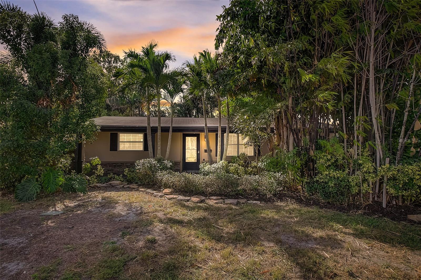 Seize this opportunity to own an exceptional home perfectly situated in the heart of Pinellas County just a short drive to the GULF BEACHES, bustling DOWNTOWN ST. PETERSBURG and a multitude of shops and restaurants. This property has excellent curb appeal with its calming BAMBOO and TROPICAL PALM TREES leading to the front entrance adorned with CUSTOM STONEWORK and ARCHITECTURAL COLUMNS. Inside, the open floor plan offers a SPACIOUS and inviting atmosphere with interior finishes that are both functional and attractive. The living room exudes a tranquil ambiance, anchored by a WOOD-BURNING FIREPLACE with a pebble inlay that adds natural elegance and the tastefully crafted built-in bookcases offer both form and function. The kitchen invites you to enjoy its STAINLESS APPLIANCES, GLEAMING GRANITE COUNTERTOPS, and UPDATED CABINETRY. Upgraded finishes in the remodeled bathroom and CROWN MOLDING throughout the home adding a consistent touch of refinement. A BONUS ROOM with lots of natural light would be perfect for a home office or playroom. THAT’S JUST THE BEGINNING! The real magic lies in the entertainer’s backyard which is a true Florida retreat complete with OUTDOOR PAVILION, BRICK PAVER PATHWAYS, STUNNING MATURE LANDSCAPING, OUTDOOR SHOWER with tumbled marble finishes, a LARGE SHED which provides ample space to be used as a workshop, creative space or additional storage. Recent updates include BRAND NEW AC (2022), NEW ELECTRICAL PANEL (2022), HOT WATER HEATER! DON’T MISS OUT, SCHEDULE YOUR PRIVATE TOUR TODAY!!