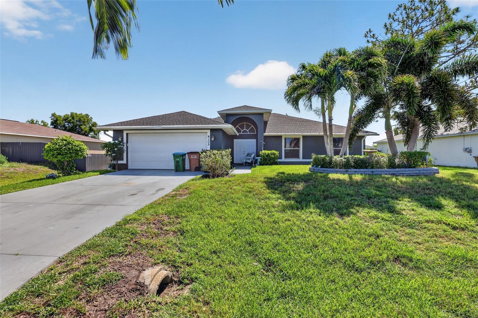 Welcome to 4105 NE 20th Place, a light filled, nearly 1,900 square foot home offering 3 bedrooms, 2 baths, and the open, split bedroom floor plan everyone is looking for in NE Cape Coral. With a spacious great room,
large kitchen with breakfast bar, screened lanai, and a generous backyard that is ideal for a future pool, this home is truly move-in ready and easy to enjoy from day one. Step inside and you’re greeted by a wide
double door entry that opens into a large living and dining area, perfect for entertaining family and friends or enjoying a quiet night in. The popular split bedroom layout gives the primary suite and guest bedrooms
excellent privacy, while the open concept keeps everyone connected in the main living spaces. The big kitchen sits at the heart of the home, with plenty of counter space, a breakfast bar, and a clear view into the bright
family room, so you can cook, watch TV, and be part of the conversation all at once. Abundant windows and sliders fill the home with natural sunlight throughout the day, creating a warm, welcoming feel in every room.
The primary bedroom is a true retreat, featuring both a large standard closet and a generous walk-in closet, plus sliding glass doors that open directly to the lanai for easy morning coffee or evening relaxation. The
oversized primary bath offers a dual sink vanity, walk-in shower, and separate soaking tub, giving you a spa like space to unwind
Two comfortable guest bedrooms and a well appointed guest bath sit on the opposite side of the home, giving family or visitors their own quiet space. An inside laundry room located just off the attached two car garage
adds everyday convenience and extra storage. Step out back to the recently added screened lanai. The backyard layout makes it easy to envision a future pool or expanded outdoor living area, with plenty of room to
design the yard you’ve always want.
Practical updates include a replaced septic system (2013), giving buyers added peace of mind and lowering one of the big ticket maintenance concerns often associated with Florida homes on septic.