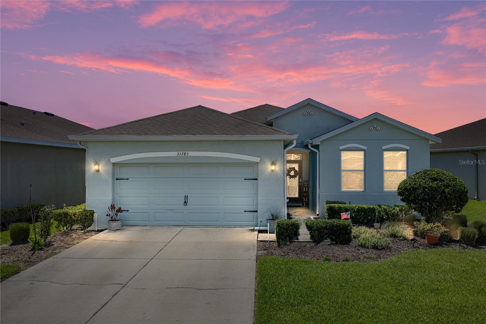 At Epperson Lagoon, the vacation feeling does not wait for the weekend, especially from this 3 bedroom, 2 bath, 2 car garage, pond-view home in the gated Liberty Commons neighborhood! Sidewalk-lined streets, mature landscaping, irrigation, and HOA-included lawn maintenance create an inviting, low-maintenance approach before the home opens into a bright, open layout with privacy built into the floor plan. A sweeping great room brings the main living areas together under one connected space, while the triple-split bedroom design keeps each bedroom comfortably separated. Easy-maintenance tile flooring runs through the living areas, giving the home a clean, cohesive look. Anchored by a built-in electric fireplace feature wall, the living room opens through sliding glass doors to the screened lanai, with the dining room and kitchen sitting close by for a natural flow when hosting and dining alfresco. Granite countertops, a central island with breakfast bar seating, stainless steel appliances, a decorative backsplash, and a roomy pantry give the kitchen a polished, practical setup with open sightlines to keep everyone connected. Custom details bring extra character to the primary suite, including herringbone-pattern wood flooring and upgraded walk-in closet organizers. In the ensuite bathroom, dual sinks with a granite countertop, a spacious walk-in shower, and a private water closet come together to provide a peaceful haven for daily routines. Across the home, bedroom 2 sits near the second full bathroom with a tub/shower combination, while bedroom 3 is set near the laundry room for extra separation from the rest of the home. Out back, the screened porch overlooks the expansive fully fenced yard and peaceful pond beyond. Start the morning with the water view, enjoy evenings outside, or let the backyard become the space for pets, play, gardening, and weekend gatherings. When you are ready for the full Epperson experience, the Lagoon is close by with crystal-blue water, sandy beach areas, cabanas, events, waterside activities, and plenty of ways to spend the day without ever leaving the community. Call today to schedule your private showing and see what makes this home such a special place to live!