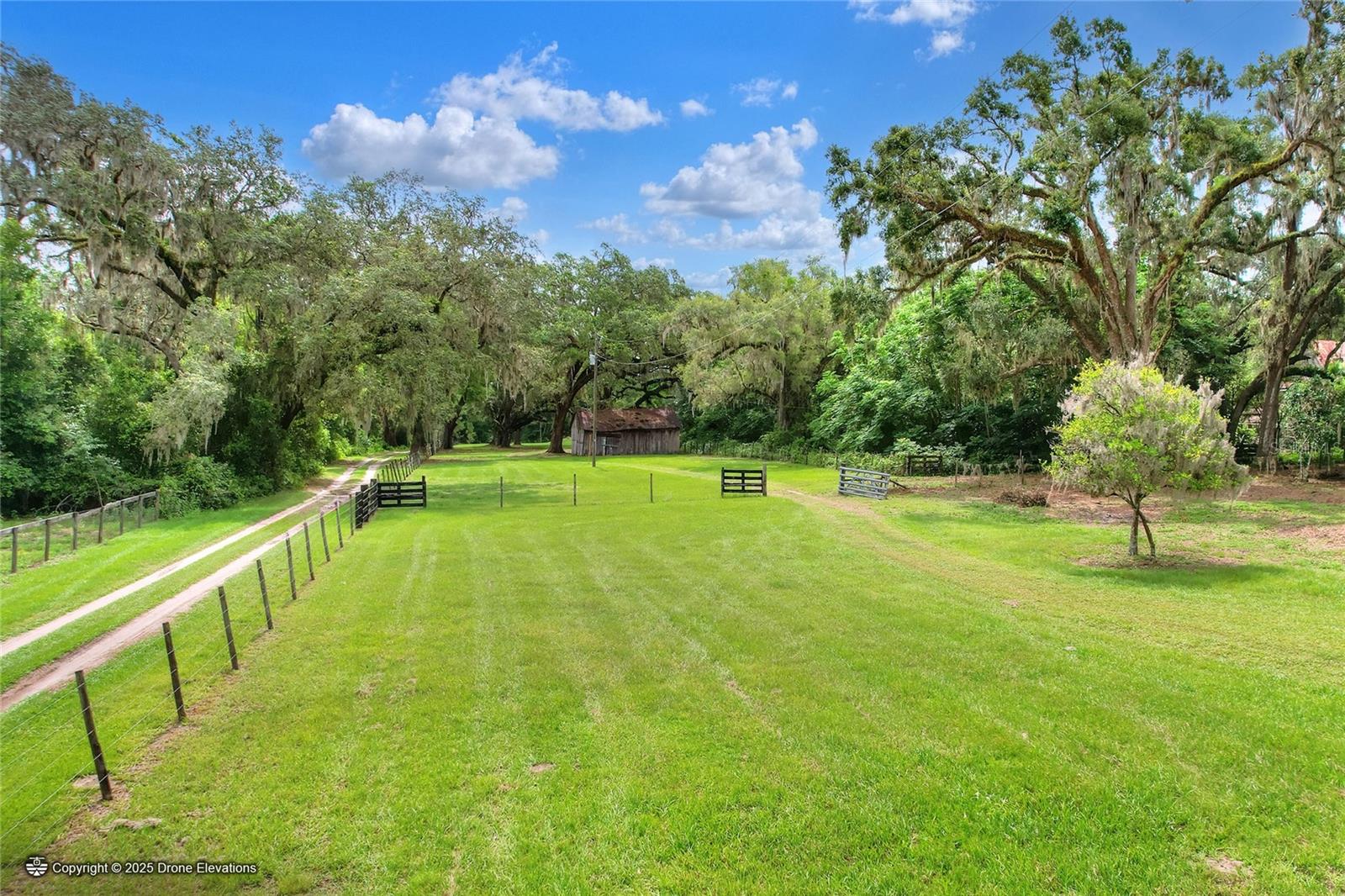Under contract-accepting backup offers. Escape to the country without sacrificing convenience. This beautiful 8.59-acre homesite in Bushnell offers the kind of property that's becoming harder and harder to find. Access begins with a stunning tree-lined canopy drive that immediately sets the tone for the peaceful setting beyond.

Fully fenced with multiple gated entrances, the property features a gorgeous mix of improved pasture, towering grandfather oaks, mature Spanish oaks, and plenty of open space to bring your vision to life. Whether you're dreaming of a custom home, a small farm, room for horses or livestock, or simply a private retreat surrounded by nature, this property offers the flexibility to make it happen.

Many of the essentials are already in place, including a private well, electricity, and two carport structures with concrete foundations that provide valuable storage and utility while you plan your build. Toward the back of the property, you'll find a picturesque pond complete with an aluminum dock and built-in seating—the perfect spot to enjoy quiet mornings, afternoon fishing, or spectacular Florida sunsets.

Located in desirable Flood Zone X and zoned RR5C, this exceptional parcel offers the freedom and versatility that acreage buyers are searching for. The combination of mature trees, usable pasture, existing improvements, privacy, and natural beauty creates an incredible opportunity to build exactly the lifestyle you've been waiting for.

If you've been searching for buildable land in Bushnell or Sumter County with a well, electricity, fenced acreage, beautiful oak trees, and a peaceful country setting, this property deserves a place at the top of your list.