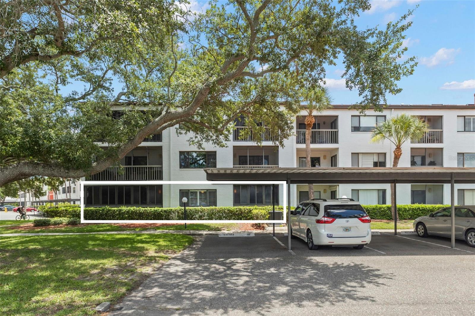 WOW! Checkout this spacious 1st-floor, corner-unit, spacious assigned carport, split-floor plan condo with 3-bedroom, 2-bath home offering serene pond views, two enclosed porches, abundant storage, and a thoughtfully designed split-bedroom floor plan. High ceilings, crown molding, 5.5-inch beveled baseboards, ceiling fans, and an open layout create an inviting atmosphere, while large windows and sliding glass doors fill the home with natural light and showcase peaceful pond view and oak-lined grounds views.

The main living and dining areas provide plenty of room for everyday living and entertaining, while the (2012 fully updated) centralized kitchen features granite countertops, solid wood cabinetry, pull-out drawers, a breakfast bar, pantry storage, and a dedicated dining area ideal for casual meals or larger gatherings.

Privately situated on one side of the home, the primary suite offers a comfortable retreat with a walk-in closet, an ensuite bath, granite countertops, direct access to its own enclosed porch, and tranquil views of the oak-lined grounds beyond the windows.

Two additional bedrooms provide flexibility for changing needs and lifestyles. One bedroom features laminate flooring, a walk-in closet, and direct access to the larger enclosed porch, while the third offers generous closet space and convenient access to the guest bath, also with granite countertops.

A standout feature of this home is its pair of enclosed porches. The larger porch spans nearly 19 feet and offers a front-row seat to the community’s mature oak canopy, sparkling pond, and fountain views. The second enclosed porch, accessible from the primary suite, creates an additional private retreat and includes an adjoining storage room.

Built for comfort and peace of mind, the home features double-pane hurricane-rated windows (2012) code standards, a fire sprinkler system, fire alarm protection, secure coded building entry, keyed side building entry, assigned covered parking, private storage, and an interior laundry room.

Residents enjoy access to a heated community pool, clubhouse, community kitchen, library, game room, tennis courts, sidewalks, and gathering spaces designed for social events and activities year-round. The condo comes with a spacious carport for easy access to the building's side entrance. There is many visitor spots in front of the building as well.

The monthly HOA fee covers cable TV, Spectrum internet, water, trash, sewer, exterior pest control, exterior maintenance, grounds maintenance, maintenance repairs, pool maintenance, private roads, reserve funding, common area expenses, and community amenities, helping simplify day-to-day living.

Ideally located in the heart of Clearwater, you’ll be minutes from Countryside Mall, Whole Foods Market, Ruth Eckerd Hall, Mease Countryside Hospital, the Philadelphia Phillies Spring Training complex, and an abundance of shopping, dining, parks, golf, and entertainment. Tampa International Airport, downtown Safety Harbor, Dunedin, and the Gulf beaches are all within easy reach.

Combining generous square footage, flexible living spaces, beautiful pond views, extensive amenities, and a welcoming community setting, this home offers a comfortable, low-maintenance lifestyle in one of Clearwater’s most convenient locations.