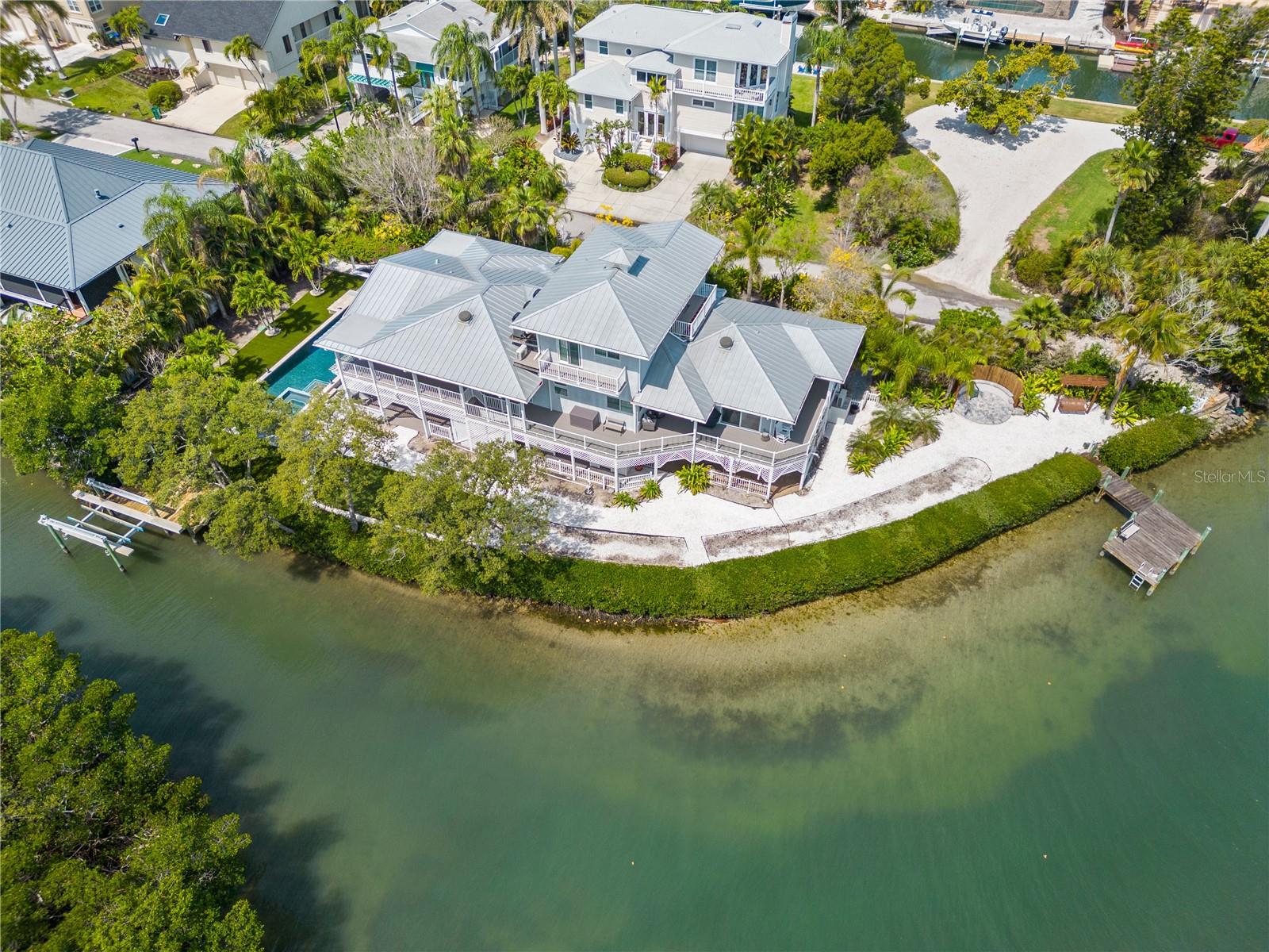Nestled in the North Longboat Key area, this stunning five-bedroom home rebuilt in 2014 with new pool and many other features offers unparalleled luxury and breathtaking views. As you step through the sliding glass doors from the main living area to the terrace, you are greeted by the expansive vistas of Sarasota Bay and the Intercoastal Waterway. This property is an epitome of modern elegance, featuring high-end finishes and an array of amenities designed for comfort and style. Key features of the home include a gourmet kitchen equipped with the latest high end appliances ideal for culinary enthusiasts. The home has been recently updated with modern touches throughout plus a new roof. The four bathrooms are newly renovated with premium fixtures. The home has an elevator that accesses all levels. The spacious three car garage ensures plenty of room for vehicles and storage.The outdoor oasis features a hot tub and heated swimming pool, outdoor grill and under cover sitting perfect for unwinding and entertaining. For the boater two docks are on the property one with a 10,000 pound lift. Imagine waking up to the serene beauty of Sarasota Bay every morning. This home offers a unique living experience where nature and luxury intertwine. Whether you are entertaining guests or enjoying a quiet evening with family, the seamless indoor-outdoor living spaces provide a perfect backdrop. The hardwood floors add a touch of warmth, while the high-end finishes ensure an ambiance throughout.
This North Longboat property is a must see for anyone seeking a luxurious lifestyle combined with natural beauty. With its modern amenities, prime location, and stunning views, it stands out as a dream home. Don’t miss the opportunity to make this exquisite residence your own.This north Longboat location is near many outstanding restaurants and Anna Maria Island. The azure waters of the Gulf of Mexico and the beach are just steps away.