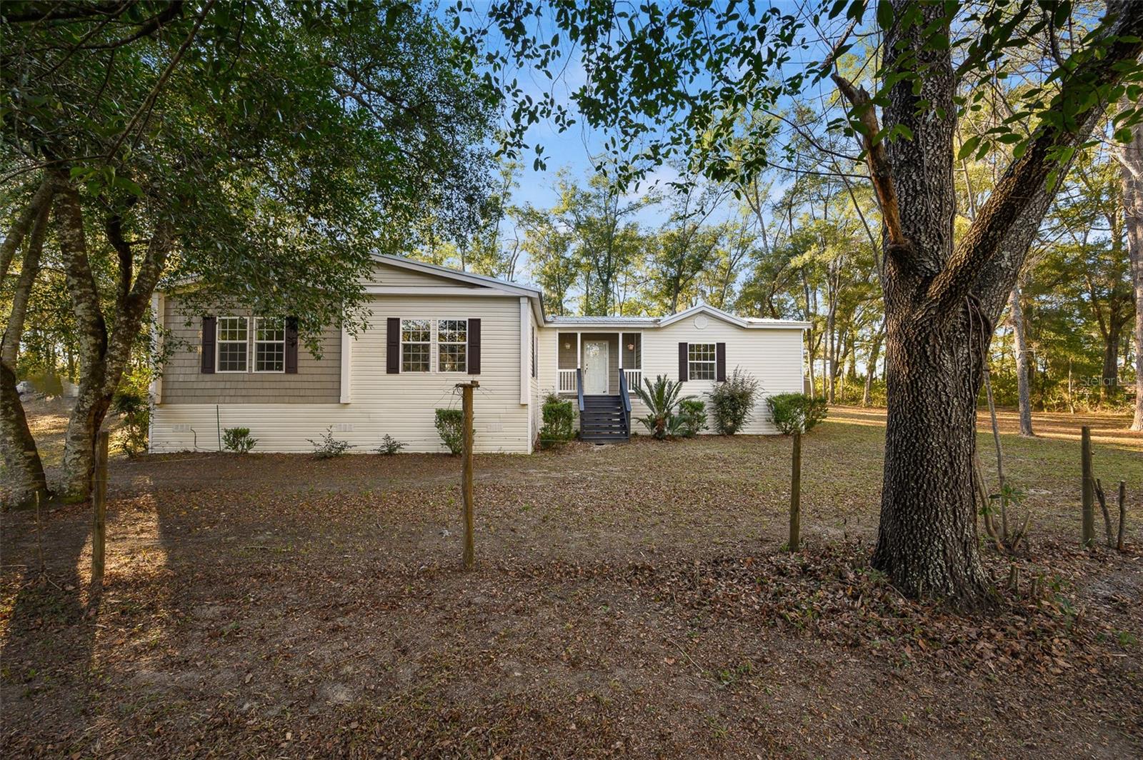 NOTE: Seller is offering $5,000 towards Buyer's Closing Cost. Located on 5 private acres, this beautifully remodeled 3-bedroom, 2-bath triple-wide manufactured home with a bonus room offers the perfect blend of space, comfort, and privacy. With approximately 2,360 square feet, the home features a spacious split floor plan designed for both everyday living and entertaining. Inside, you are welcomed by an open and inviting living area with both a large living room and a separate family room with a fireplace. The oversized kitchen is a standout feature, offering an impressive amount of new cabinetry, granite countertops, a grand center island, and plenty of room to gather. Fresh interior paint, all new flooring, updated hardware, and modern finishes throughout give the home a clean, move-in-ready feel.
The private primary suite is located just off the main living area and includes a walk-in shower, soaking tub, and a generously sized walk-in closet with all new hardware. On the opposite side of the home, you will find two additional bedrooms, a second full bath, and a bonus room that offers flexibility for an office, playroom, guest space, or hobby room. An oversized laundry room, complete with washer and dryer, adds even more convenience.
Outside, the property offers fenced pasture space and a large yard with room to garden, expand, bring animals, or simply enjoy the secluded surroundings, all with no HOA to limit how you use your property. Major updates include a roof replaced in 2020 and HVAC updated in 2021. Conveniently located in Archer, this property offers easy access to the University of Florida, UF Shands, and the VA.