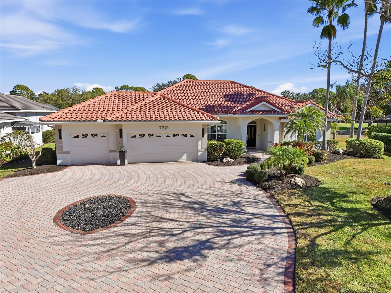 One or more photo(s) has been virtually staged. PRICE IMPROVEMENT! Now offered at $999,999.  7321 Links Court represents a rare opportunity to own over 1/2 acre of privacy in the heart of Sarasota & Lakewood Ranch. This is the kind of property buyers look for but rarely find: space to breathe, room to live, and a peaceful setting just minutes from everything Sarasota has to offer. Perfectly positioned, the home is just 2.5 miles from UTC, providing everyday convenience without the congestion. Downtown Sarasota, Sarasota-Bradenton International Airport, and I-75 are all just minutes away, with easy access to Lakewood Ranch and the surrounding Gulf Coast communities. Inside, the home features a flexible four-bedroom, three-and-a-half-bath split floor plan designed for real life. The rear bedroom is tucked behind a pocket door with direct access to the pool bath, making it ideal for private guest quarters, a mother-in-law suite, or a quiet home office. The primary suite offers a comfortable retreat, with custom closets designed for organization and everyday ease. Thoughtful updates continue throughout the home, including a refreshed laundry room with new cabinetry and quartz countertops, along with an updated full guest bath near the secondary bedrooms featuring a walk-in shower, quartz countertops, and a new vanity with soft-close drawers. The kitchen is warm and highly functional, offering granite countertops, solid wood cabinet doors, generous storage, and 2025 GE Profile appliances, including a double oven, microwave, and dishwasher, a space ready to enjoy today or customize over time. Luxury vinyl plank flooring flows throughout the home, complemented by crown molding in the living and dining areas and new ceiling fans in most rooms and outside lanai. Outdoor living is where this home truly comes to life. A hurricane-rated panoramic pool cage (2025) frames the expansive lanai, where the view opens to the 12th fairway of Palm-Aire Golf Course, anchored by three magnificent oak trees that create a calm, natural setting rarely found this close to everyday conveniences. Recent exterior improvements include 2026 Pentair Pool Heater, Pump and Blower, 2026 concrete stained pavers on back lanai, 2024 fresh exterior paint, 2025 travertine stone on the front patio, and UBA power sealed driveway, all thoughtfully maintained to enhance both curb appeal and long-term durability. Additional highlights include a large circular driveway and a three-car garage, offering ample space for vehicles, storage, or a golf cart. The rear portion of the garage was converted into an air-conditioned office or workout room by prior owner, providing flexible usable space while still maintaining practical garage functionality. The roof was replaced in 2017, with updated flashing completed in 2025. AC 2025. The community offers a low HOA and no CDD, adding long-term value and affordability. This is a home that delivers privacy, space, and an exceptional location, a rare combination that is increasingly hard to find.