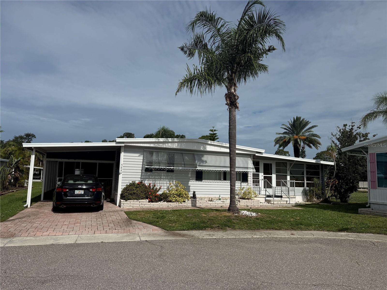 Don't miss this well-maintained 2-bedroom, 2-bath doublewide situated on an oversized lot on a private road in the highly desirable Japanese Gardens 55+ community. Laminate flooring runs throughout the main living areas, with tile in the kitchen and bathrooms.The bright Florida room adds approximately 340 square feet of additional living space and is filled with natural light from walls of windows. The spacious primary suite features a walk-in closet and private ensuite bath, while the guest bedroom also offers a walk-in closet.Relax or entertain on the large screened lanai, and enjoy the convenience of a storage shed with washer and dryer.Japanese Gardens offers resort-style amenities including pickleball, bocce, shuffleboard, a clubhouse, heated pool, spa, and an active social calendar. Come experience the Florida lifestyle in this welcoming, resident-owned community!