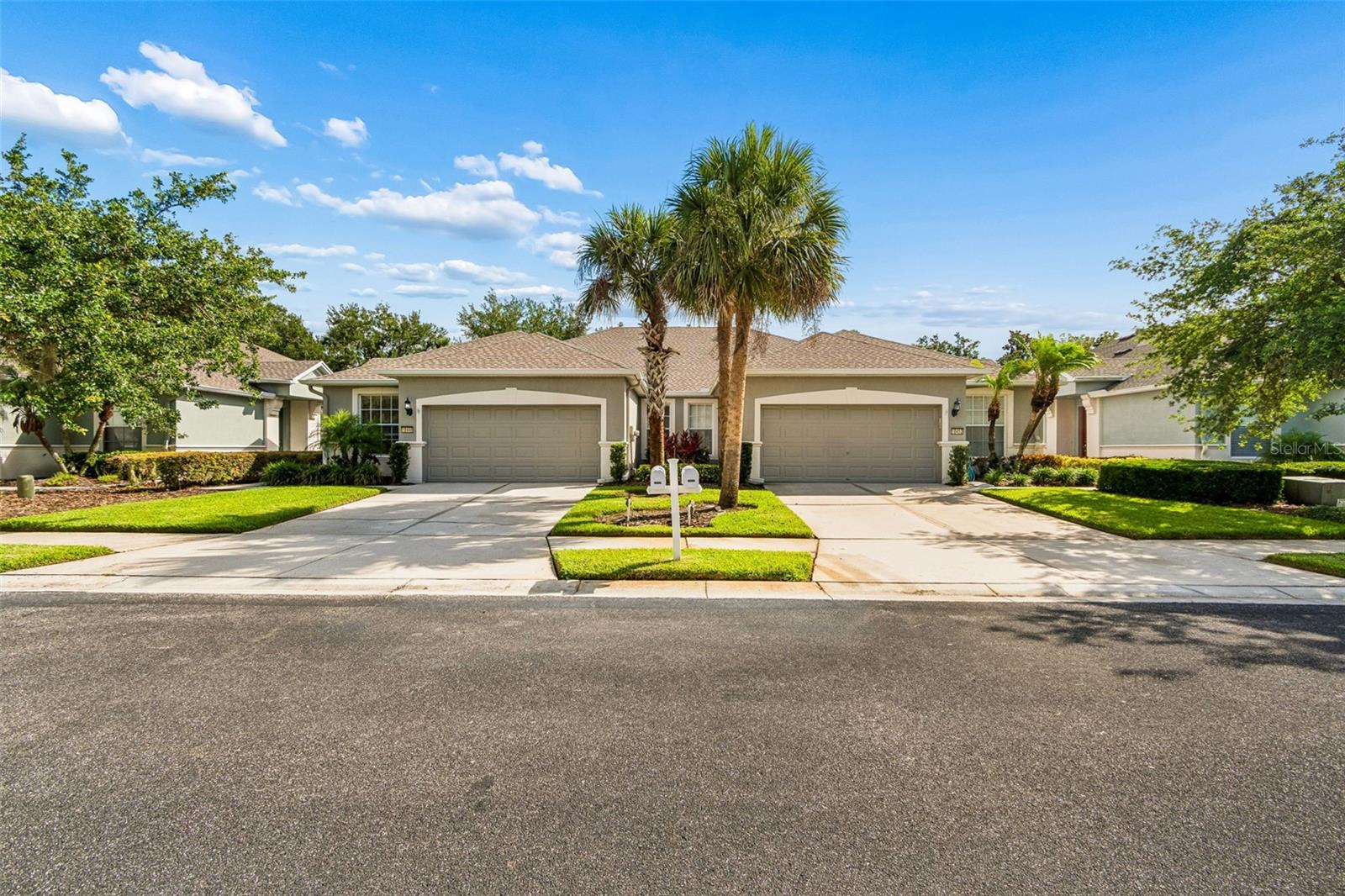 Outstanding opportunity to own a home in much desired Harrison Ranch. Set in the peaceful gated, maintenance free Normande West section with only 30 residences, you will notice the well-maintained grounds, mature landscaping, sidewalks on both sides of the road and décorative streetlights. This 2 bedroom, 2 full bath villa also boast a den/study with double doors at the front of the home and a large glassed-in air-conditioned Florida room (not included in sq. ft) at the back. The roof was replaced in 2025. Inside you will see a well laid out floorplan with a dining room, kitchen with SS appliances, quartz countertop, wood cabinets and décorative tile backsplash overlooking the nice-sized living room and a breakfast area. The dining room, living room, den and both bedrooms have luxury laminate flooring and the Florida room is ceramic tile planks. The spacious primary bedroom with relaxing views of the rear yard greenspace leads to the primary bath with dual sinks and a beautifully remodeled shower. There is also a full sized 2-car garage. You will love the amenities offered at Harrison Ranch including a near-by pool area only for use by Nomande East and West residents. The main recreational area includes a large clubhouse with 24hr fitness center, full kitchen, dining areas, junior Olympic size pool, basketball, tennis and pickleball courts and 5 miles of walking trails. Harrison Ranch is located very convenient to all services including the Ellenton outlet mall and Creekside Commons shopping. Access to international Airports, St.Pete, Sarasota, Lakewood Ranch, Fort Hammer boat ramp and our award-winning west coast beaches is made easy via I-75 and Hwy 301. You will love living in Harrison Ranch. Schedule your showing today !