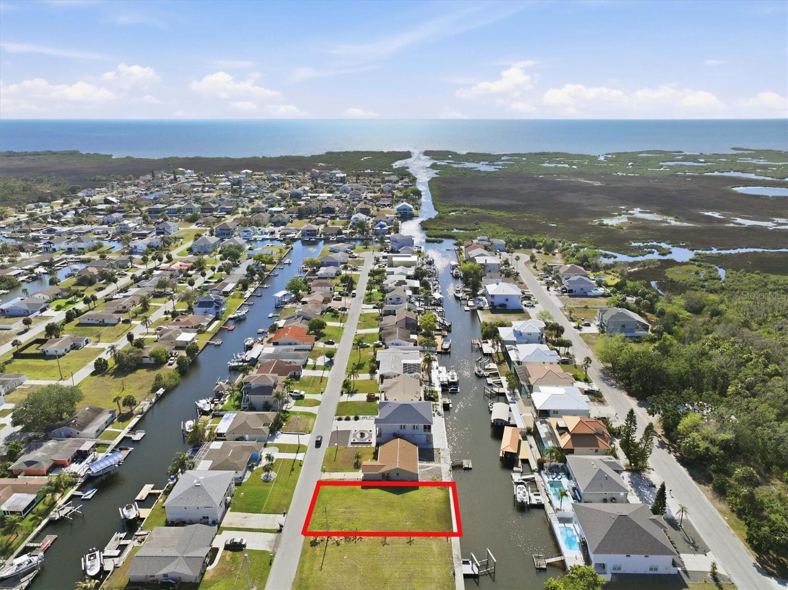 Direct Gulf Access Lot with Seawall – Boater’s Dream!

Live the ultimate Gulf Coast boating lifestyle with this rare direct-access residential building lot in the highly desirable Sea Pines community of Hudson. Featuring 60 feet of concrete seawall on a saltwater canal with no fixed bridges, giving you effortless access to the open Gulf of Mexico in just minutes.

Spend your days watching dolphins and manatees glide through your backyard while casting for redfish, snook, and snapper right from your property. Whether you're an avid angler or a sunset cruiser, this lot delivers the true Florida waterfront experience.

One of the biggest advantages of this property is flexibility… There’s no timeline to build… No HOA …  You can build a dock and lift without having to build a home.  

Welcome to Sea Pines – Hudson’s Hidden Boating Sanctuary
Tucked away off Old Dixie Highway and surrounded by natural marshland, Sea Pines offers a peaceful coastal setting centered around boating and outdoor living. A Coast Guard-marked channel provides reliable, well-maintained access to the Gulf—one of the many reasons this community stands out among waterfront neighborhoods.

From your dock, explore some of the Gulf Coast’s most popular destinations:
Head south to the Anclote Key Sandbar, a local favorite for relaxing in shallow, crystal-clear water
Continue to Anclote Key Preserve State Park, an unspoiled barrier island perfect for beach days
Cruise north to the Hernando Beach Flats, a family-friendly sandbar ideal for social boating
Venture further to the Weeki Wachee, Homosassa, and Crystal River systems, known for waterfront dining, vibrant marine life, and refreshing 72-degree spring waters

Sea Pines residents enjoy access to a private community boat ramp for just $115/year, making it easy to launch and explore whenever the mood strikes. The community features an optional civic association (no strict HOA), offering freedom without sacrificing neighborhood charm.

Located just minutes from Hudson Beach, waterfront restaurants, marinas, and everyday conveniences along US-19—including shopping, dining, medical facilities, and more—you’ll have everything you need close by. Tampa International Airport is approximately an hour away, and Orlando’s world-famous attractions are just 90 minutes away.

Build your dream Gulf Coast fishing home—or start enjoying the boating lifestyle today. This is more than a homesite… it’s your gateway to life on the water.