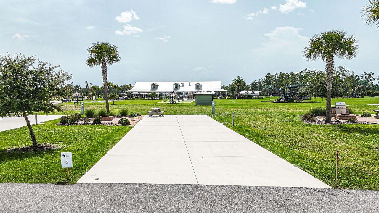 Discover an exceptional opportunity to own a slice of luxury in one of Central Florida’s most sought-after RV resorts at Resort at Canopy Oaks. Whether you're seeking a refined personal retreat or a professionally managed income-producing property, this rare 45’ x 90’ RV site offers the best of both worlds.

Set within a 435-acre gated paradise, ownership includes access to a tropical tiki bar, resort-style pool and hot tub, pickleball courts, fitness center, full-service spa, and on-site dining — all designed for effortless luxury living in a carefree, managed community.

Ideally positioned along the perimeter, Lot 5 offers pool and playground views with added privacy. The upgraded paver patio and fire pit create an inviting space for relaxing or entertaining, just steps from the amenities. The generous 20’ x 70’ concrete pad features full hookups (20/30/50 amp) and easily accommodates Class A, Class C, fifth wheels, travel trailers, or even a small park model—making it the perfect carefree seasonal retreat. 

Beyond the gates, enjoy easy access to world-class Gulf and Atlantic beaches, major airports, and iconic destinations like Universal Studios Florida and Disney World.

At Resort at Canopy Oaks, you’re not just reserving a site — you’re embracing a lifestyle, with the flexibility to generate rental income when you’re away and the opportunity to own your own piece of Florida paradise.

**Developer incentives are currently available, adding even more appeal to this exceptional opportunity.**