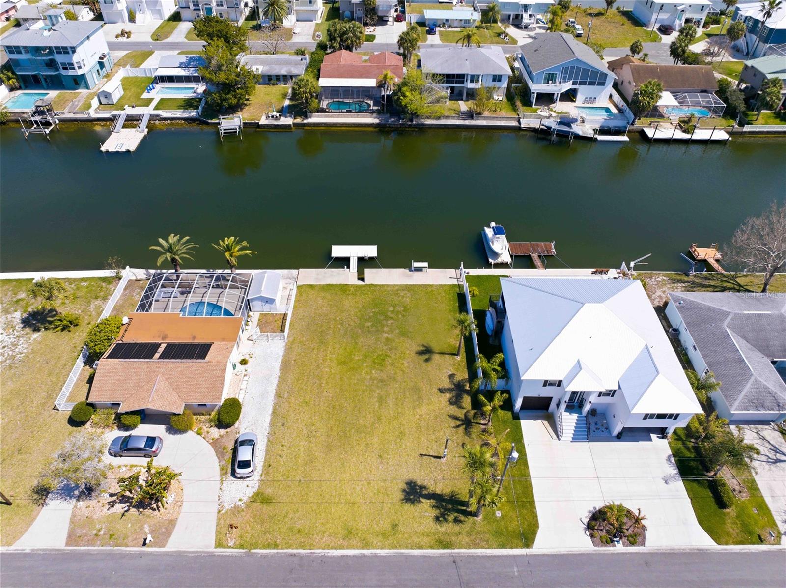 Large Price Adjustment! Prime Vacant Waterfront Lot with Direct Gulf Access in Hernando Beach. This ready-to-go Deep Water Canal lot is just minutes from the Gulf. This is the perfect spot to park your houseboat, sailboat, or cabin cruiser with water/electric right at the dock. Features include a Floating Dock, Fish Cleaning Station, and 70 Feet of Seawall with steps for easy access into the water. Impact Fee have already been paid. Electric, Water and Sewer are connected. Build your dream home now or later. No deed restrictions or HOA fees, just freedom! Hernando Beach offers many dining options, local bars, parks and "The Flats" locally famous sandbar. Fishing, scalloping, kayaking and gorgeous sunsets all in your "backyard". Come Take a Look and Vacation Where You Live!