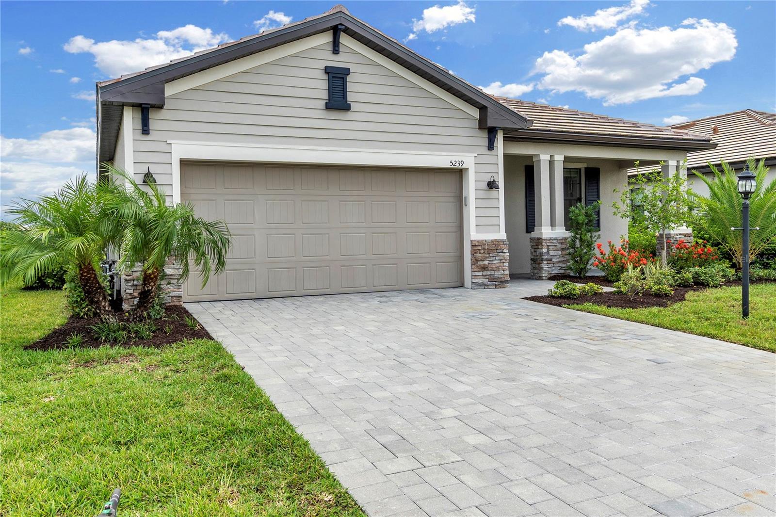 Welcome to 5239 Coral Reef Way, located in the highly sought-after gated community of Lorraine Lakes at Lakewood Ranch. Built in 2023, this beautifully designed single-story residence offers the perfect blend of modern coastal style, comfort, and resort-inspired living. Featuring 3 bedrooms, 3 full bathrooms, and an open-concept floor plan, the home is thoughtfully designed for both everyday living and entertaining. High-end finishes include crown molding, stone countertops, ceramic tile flooring, and a spacious chef’s kitchen that flows seamlessly into the living and dining areas. Sliding glass doors open to a private screened lanai with a heated pool and spa overlooking tranquil water and preserve views.

Residents of Lorraine Lakes enjoy a true resort lifestyle with access to a luxurious clubhouse, fitness center, tennis and pickleball courts, resort-style pool, restaurant, playground, walking trails, and 24-hour gated security. Conveniently located near top-rated Lakewood Ranch schools, shopping, dining, golf, and world-famous Gulf Coast beaches, this move-in ready home offers the ideal opportunity to enjoy the very best of Florida living.