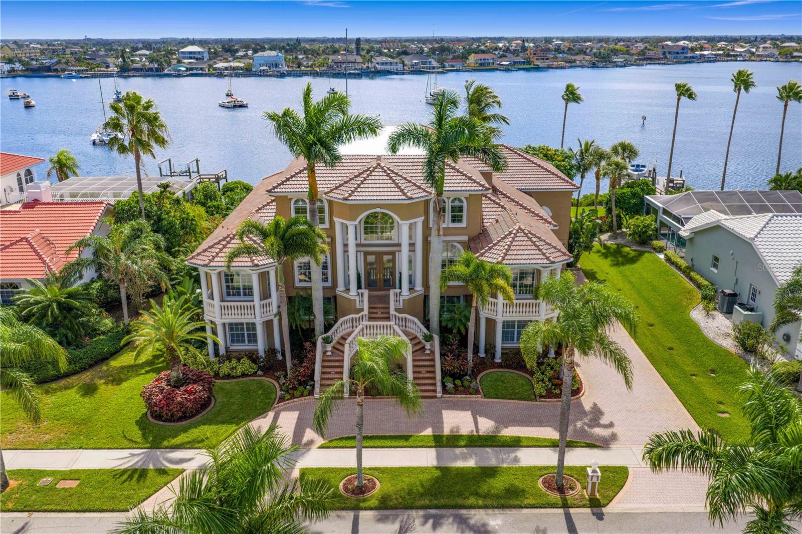 This stunning deep canal waterfront home, situated between downtown Tampa and northern Sarasota, is nestled in the gated community of Andalucia. It offers a rare blend of deep-water access, high-end design, and effortless Florida-style entertaining. Every detail has been crafted for those who desire both elegance and fun in equal measure, including a studded out elevator shaft and a chef's kitchen.

Inside, you’ll find 4 bedrooms and 3.5 bathrooms, including a serene main-floor primary suite with double walk in closets. Upstairs, you will find two additional bedrooms with access to a jack and jill bathroom, as well as a guest room and a flexible movie room both with full bath access. 

The open lower level flows directly to the sparkling pool and outdoor living spaces, making it a dream for hosting friends and family. A 4-car garage provides abundant storage, while the 2025 roof and pre-framed elevator shaft deliver both peace of mind and future convenience. 

Boaters will love access to a deep water canal with quick, direct access to the bay. You are minutes from local dining spots and a Publix grocery store, only 40 minutes to Tampa International Airport, and an hour north of Sarasota-Bradenton International airport. 

The gated community enhances the experience with clay tennis courts, a community pool, a playground, and nearly four miles of scenic sidewalks perfect for walking or jogging. Private roads minimize outside traffic and are wide enough for safe, enjoyable biking.

This is more than a home. It is a waterfront lifestyle designed for luxury, adventure, and unforgettable moments.