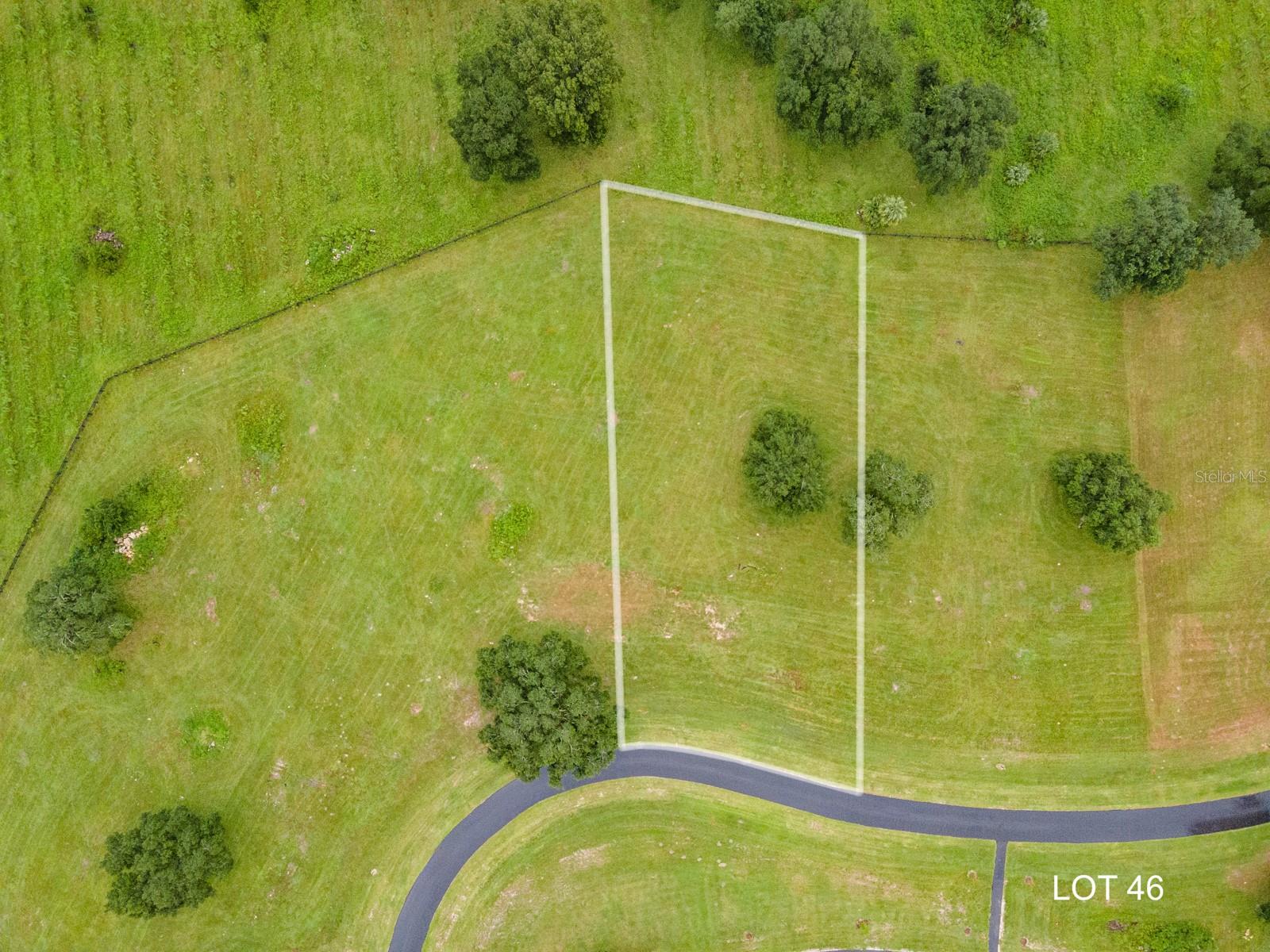Lot 46 is a premium 0.99 acre buildable homesite in the exclusive gated Parke subdivision of Flint Rock. The perfect canvas to create your dream home with AR Homes, known for their fully customizable luxury home designs that bring your vision to life. This South-facing lot boasts a private backyard overlooking a serene conservation area, setting the stage for peaceful mornings and memorable gatherings. As part of Gainesville’s first Agrihood, Flint Rock promotes a lifestyle focused on wellness, community, and a deep connection to the land. Residents enjoy more than just a home; they become part of a vibrant, sustainable community. Stroll along 2.5 miles of walking paths through lush landscapes and preserved green spaces. Experience the joy of fresh, locally grown produce from the community gardens and orchards. Flint Rock’s thoughtfully designed amenities, including an Event Barn for hosting memorable gatherings and a Residents’ Farmhouse complete with a full catering kitchen, create endless opportunities to connect with neighbors and celebrate life’s special moments. Relax by the paver fire pits, unwind on trellised swings, or take in the beauty of butterfly-filled herb gardens. Build your future at Flint Rock, where luxury living meets natural beauty and a healthier way of life awaits. Underground utilities, Clay Electric, AT&T fiber internet, private eco-friendly well/septic and more.