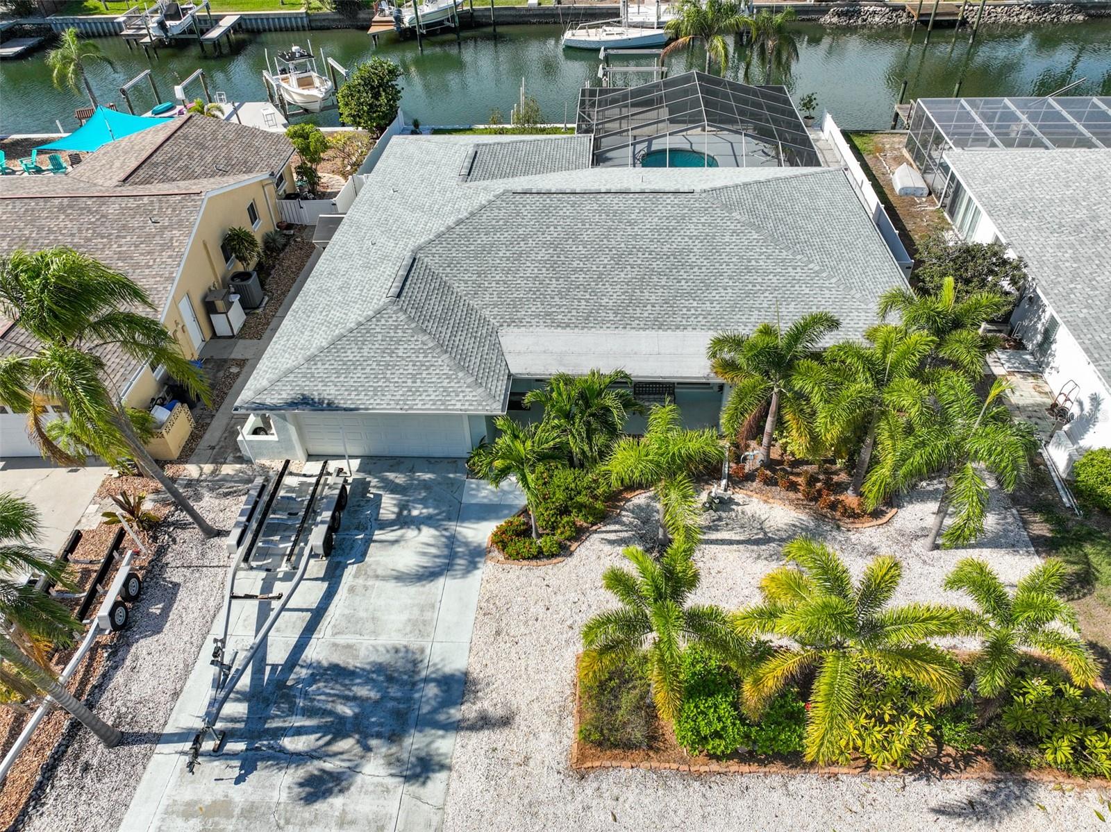 Boaters Alert! Would you like to live on a deep water canal, just one block away from Tampa Bay waters? This fabulous property offers that and much more! CERTIFIED PRE-LOVED HOME- pre-inspected and ready for the new owners!
Located in the desirable Bal Harbour community in the heart of Apollo Beach. NO CDD, NO HOA!

Starting with the gorgeous tropical landscaped front yard, which offers room for extra parking and an inviting front porch. The home boasts of  4 spacious bedrooms/2 baths and an open floor plan concept. The living room organically flows to the modern kitchen with stainless steel appliances, 42" cabinetry, and Quartz countertops. Sliding doors and oversized windows off the living room are showcasing the great backyard. 

Entertainment is a bliss with the screened covered lanai, sparkling pool, and water views. A 10,000 lb boat lift will accommodate your boat, while two floating docks will take care of your other water toys.

Most updates were done in the last 2-3 years: Saltwater POOL, Hurricane Impact Windows, Screened Lanai, New Seawall, New Roof, Boat Lift, etc. Please ask the agent for an extended features and upgrade list, inspection report, and other useful information. Welcome to Florida Living!