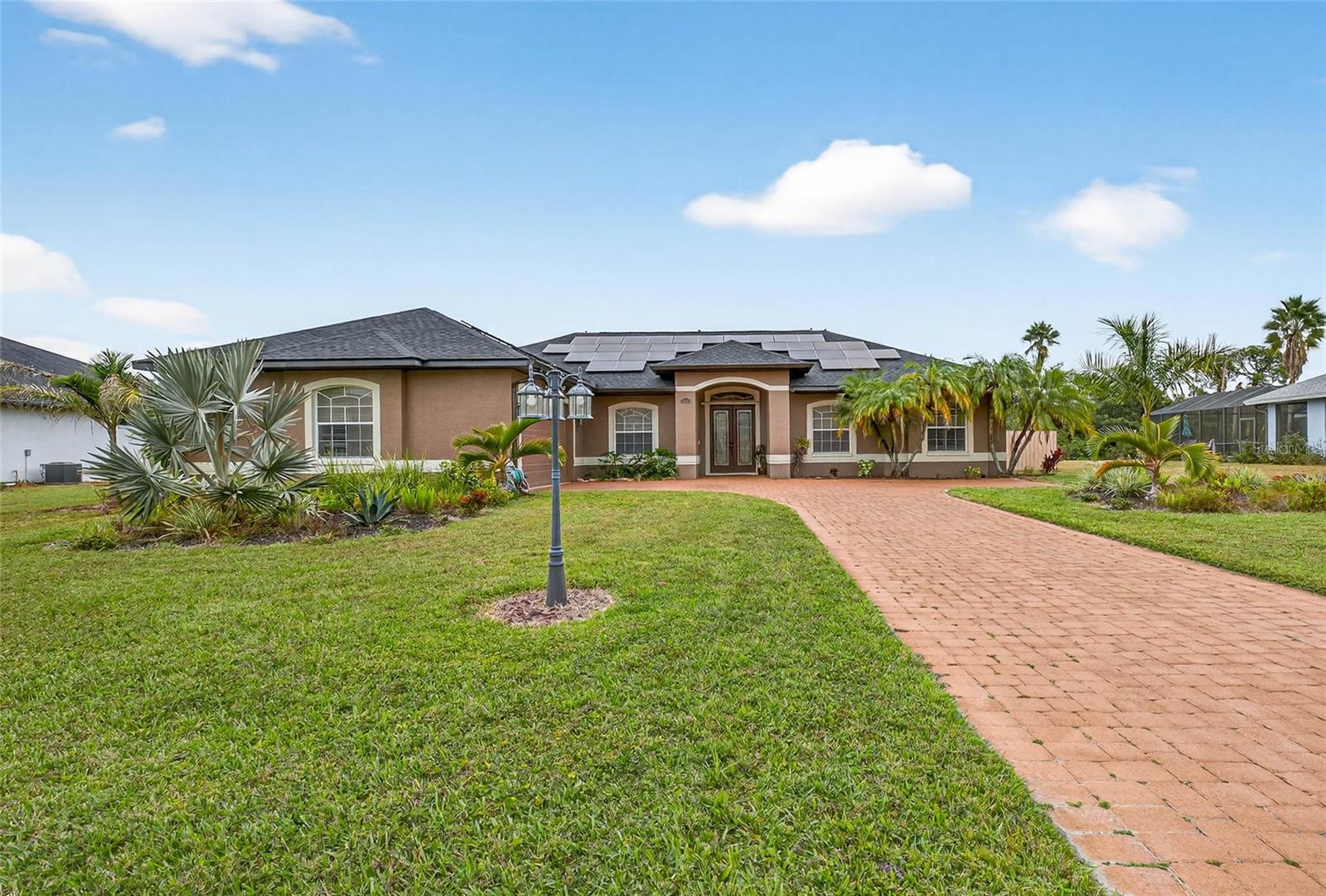 One or more photo(s) has been virtually staged. Welcome to your stunning new home, a beautifully designed three-bedroom, two-bathroom residence with a bonus room that’s florida style living with tranquil lakeside charm. As you enter, you’ll be captivated by the open-concept layout that seamlessly connects the spacious living area to the gourmet kitchen, making it ideal for entertaining and family gatherings.

The kitchen is a culinary dream, featuring granite countertops, a gorgeous marble backsplash, and wood cabinets that provide both style and functionality. The thoughtful design allows for ample storage and prep space, ensuring that cooking is a pleasure.

Retreat to the serene primary suite, which offers a private en-suite bathroom with a jacuzzi tub and a peaceful atmosphere, perfect for unwinding after a long day. Two additional bedrooms are generously sized, making them perfect for family, guests, or a home office.

Step outside to your personal paradise—an inviting private pool that overlooks a beautiful lake view. The outdoor space is perfect for summer barbecues, relaxing afternoons, or simply taking in the stunning sunsets over the water.
This home also offers a less than 2 year old roof and newly installed solar panels for energy efficiency, which have been paid in full.
With custom touches throughout and a location that offers both privacy and community, this home is a rare find. Don’t miss your chance to experience lakeside living at its finest!