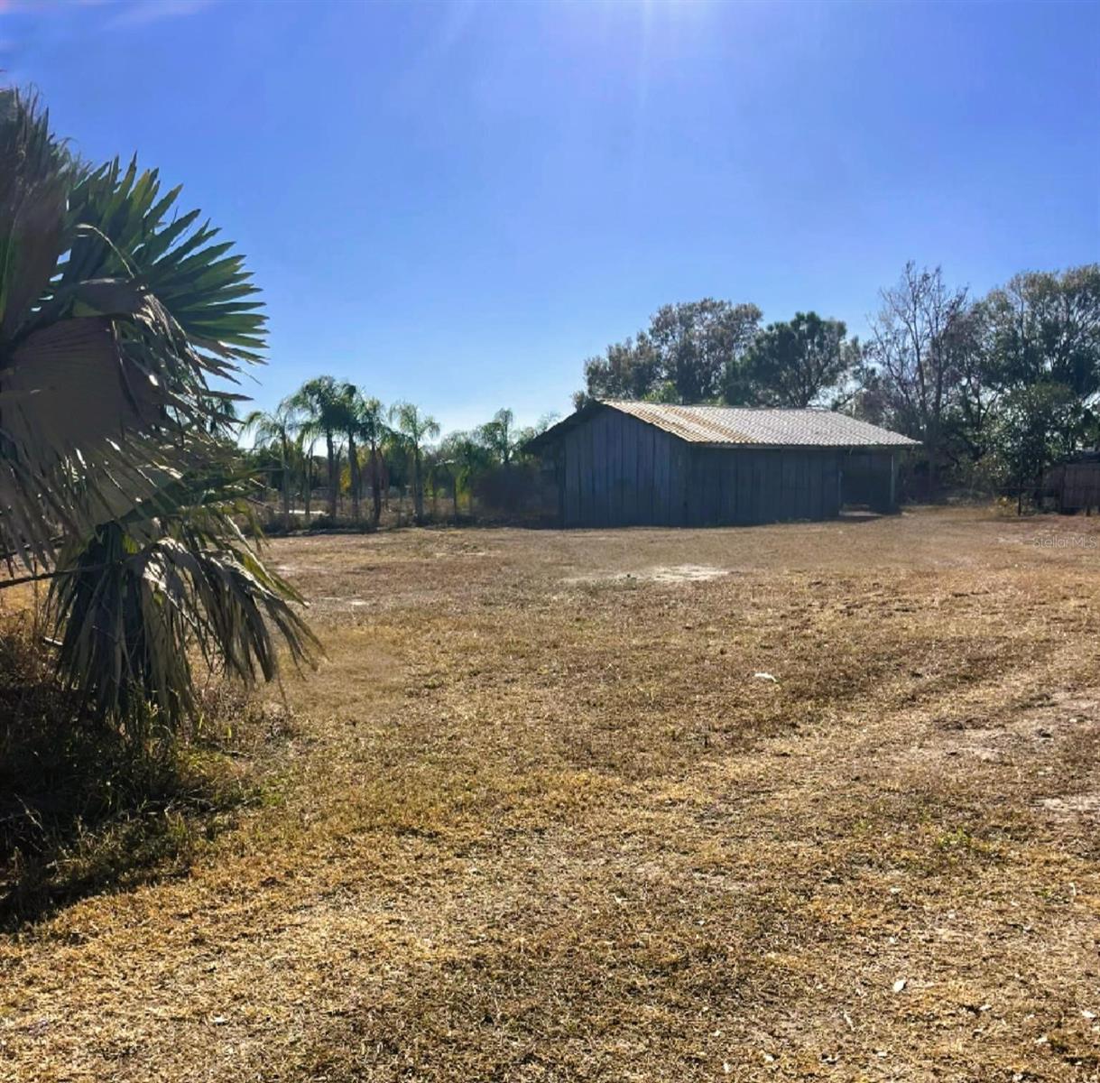Tucked away just minutes from downtown, this versatile .49-acre parcel sits on the edge of town in a great up-and-coming neighborhood, with a brand-new housing development just across the street and continued improvements throughout the area. Pride of ownership is showing, with neighbors actively fixing up and upgrading their homes—making this location more and more sought after.
The parcel may have the potential to build (buyer to verify) and includes a very well-built 25x20 building already on site. Currently being used for storage, it could be a great fit for your daily needs—ideal for a home-based business setup, equipment/tool storage, or parking vehicles. An operational well is already in use on the property, and the lot is partially fenced for added privacy and functionality.
Even better, the property behind has a mobile home currently rented, and the property next door is a home currently rented. With two additional neighboring properties also available, this creates a rare opportunity to assemble three income-producing properties—a strong setup for a high-cap-rate investment package, or a buy-and-hold strategy where you could live in one and rent the others.
Buyer to do their due diligence regarding zoning, building requirements, permitted uses, and rental/income potential, and to verify any and all information with the City of Frostproof and Polk County.