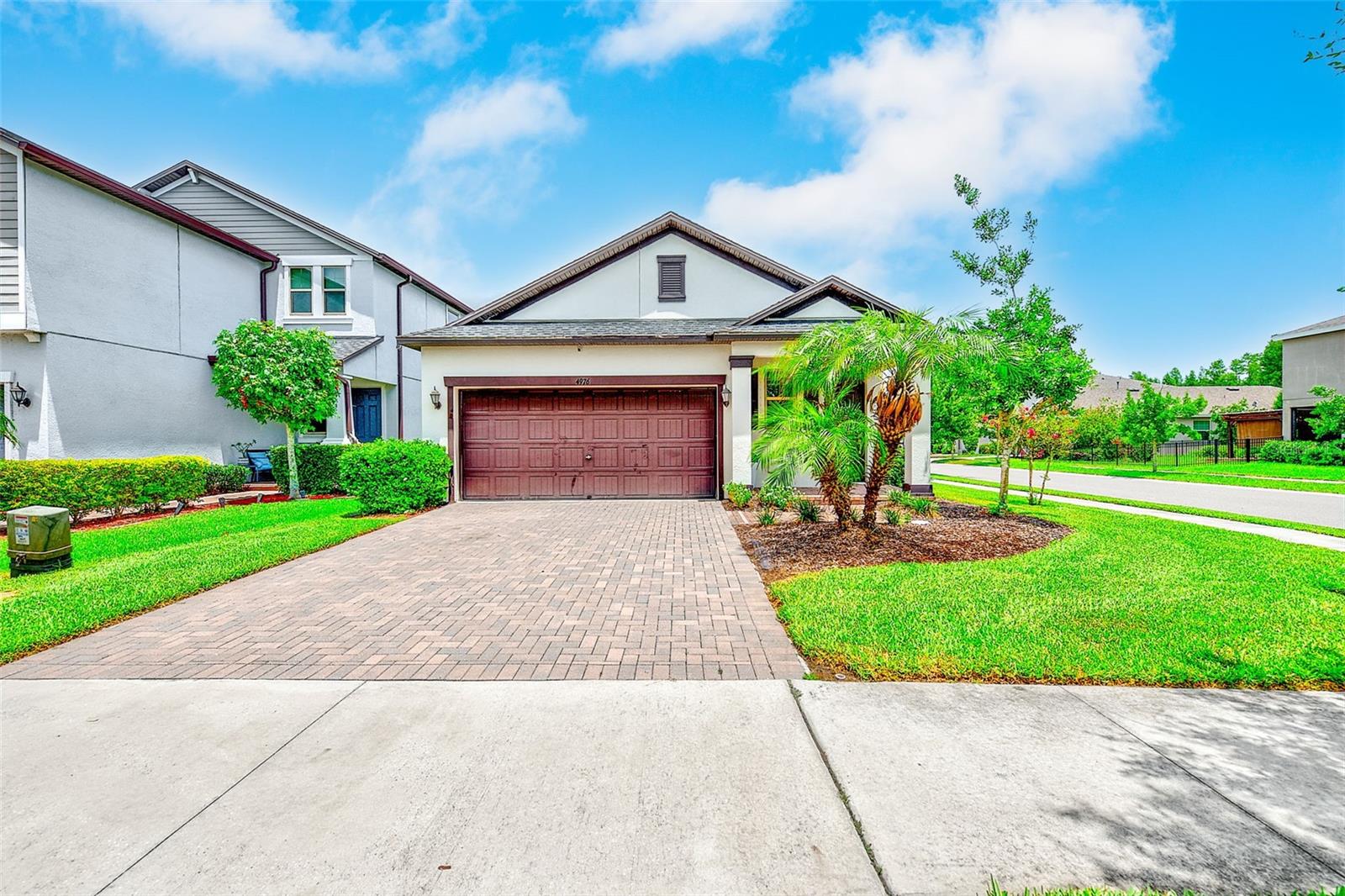 Set within Bexley, one of Land O'Lakes' most celebrated master-planned communities, this three-bedroom, two-bathroom home strikes a beautiful balance between everyday comfort and resort-inspired living across roughly 1,612 square feet. An open floor plan greets you with ceramic tile flowing throughout the living areas, complemented by crisp white shaker cabinets and elegant crown molding. The thoughtful split floorplan tucks the primary suite away for privacy, where you'll find an en suite bathroom featuring dual sinks, a shower, and a stylish barn door, plus a generous walk-in closet. Two additional bedrooms offer ample room for family or guests, sharing a well-appointed hall bath with a shower-tub combination. A dedicated interior laundry room and a two-car garage add welcome practicality, while the screened back patio and fenced yard invite you to unwind outdoors. Life in Bexley, however, extends far beyond your front door. Residents enjoy exclusive access to two stunning pools, a cutting-edge fitness center, the beloved Twisted Sprocket Café, an open-air game room, multiple dog parks, playgrounds, and miles of paved trails winding through preserved nature. The Hub at Bexley delivers coffee, dining, and retail just moments away. The location shines just as brightly. Zoned for highly rated Pasco County schools and minutes from the Suncoast Parkway and State Road 54, commutes to Tampa, local beaches, and the airport feel effortless. Shopping centers, medical facilities, and daily conveniences sit close at hand.