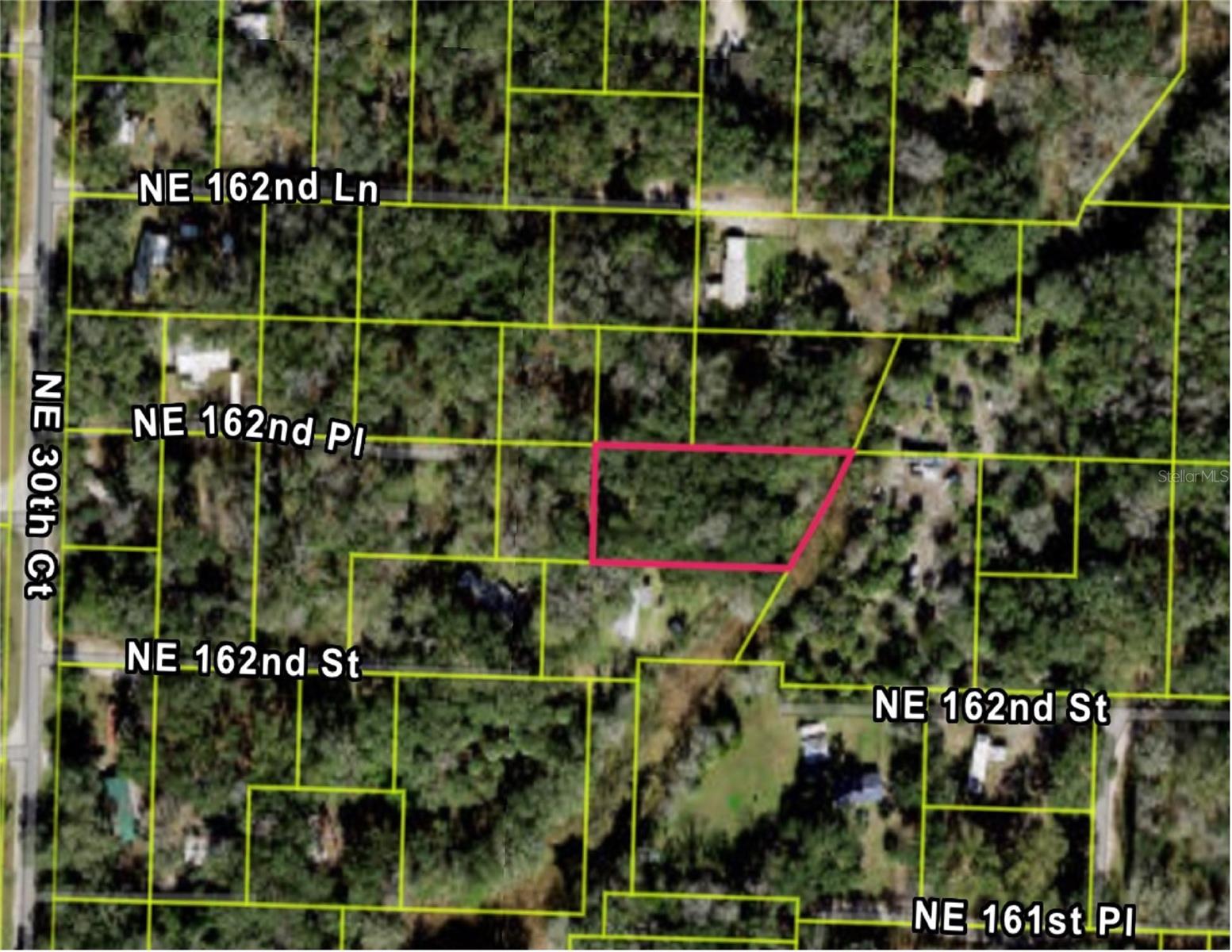 Located at 3198 NE 162ND PL, CITRA FL 32113 is a Peaceful Half-Acre Retreat – Close to Gainesville & Ocala!  Discover a hidden gem, just over half an acre, tucked away from the hustle and bustle of the city, yet conveniently located near Gainesville and Ocala. Whether you're looking to build a weekend getaway or create your own country escape, this versatile lot offers the freedom to make it truly your own.  With no HOA, you'll enjoy the flexibility to bring your vision to life. The property is bordered by a canal on one side, adding a touch of natural charm and potential for serene views. Nearby lots are already equipped with septic and well, making utilities more accessible. Embrace the beauty and simplicity of Florida country living—spacious, peaceful, and full of potential! INFORMATION IS DEEMED RELIABLE BUT NOT GUARANTEED…TO BE VERIFIED BY THE BUYER AND/OR BUYER'S AGENT INCLUDING UTILITIES.