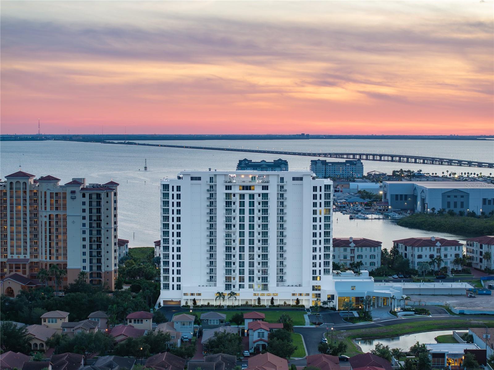 Introducing AQUA at Westshore Yacht Club on the grounds of the exclusive gated waterfront community in South Tampa. Residence #903, a 3 bedroom, 3.5 bath plus a den with 2,356 Sq. Ft and an additional East facing terrace accessed from the 3rd bedroom. Westshore Yacht Club’s newest residential tower: standing 17 floors, offering 77 luxurious condominium residences with sweeping sunset views and sunrise city views. Secure fob private elevator that opens into your private entry foyer. Interiors boast the finest finishes such as Italkraft premium cabinetry, quartz waterfall countertops, large format porcelain tile, Sub-Zero and Wolf appliances with induction stove top. Wide-open sun filled living and dining rooms with floor to ceiling windows and sliders accessing the West facing terrace, offering amazing sunset and Bay views.  Generously sized Owner’s Suite enjoys 2 walk-in closets, spa-inspired Owner’s bath with large walk-in-shower and freestanding soaking tub, private lavatory enclosure, 2 separate vanity locations with premium fixtures. Amenity rich, the building features a rooftop sky pool with bay views and private cabanas, with breathtaking views of Old Tampa Bay, plus a 3rd floor pool with spa, outdoor grilling station and lounge area.  Spacious and elegantly appointed club room with conversational seating areas, sports lounge and billiard area and private dining room. State of the art golf simulator, theater with plush seating, private offices, children’s playroom and 2 fully furnished guest suites. Bay Front fitness center on the 17th floor with yoga and spin room. Climate controlled storage for each residence on the same level. Residents and guests will be welcomed by valet attendant under the covered porte-cochere entrance leading to the residential lobby, with signature ceremonial staircase that leads to the second floor lounge library. 24/7 staffed lobby, on site property manager and service personnel ensure an effortless lifestyle. Westshore Yacht Club is South Tampa’s premier unique Gated waterfront community, boasting the exclusive members-only Bay Club and Marina, 175 boat slips, two resort style swimming pools, outside Tiki Bar, and indoor fine dining, 806 Sunset bar, Day Spa, fitness center, community, and dog parks. All this and only 30 minutes to the beaches, 15 minutes to downtown Tampa and St. Petersburg, as well as Tampa and St. Pete Airports, and all the restaurants & shopping Tampa Bay has to offer.