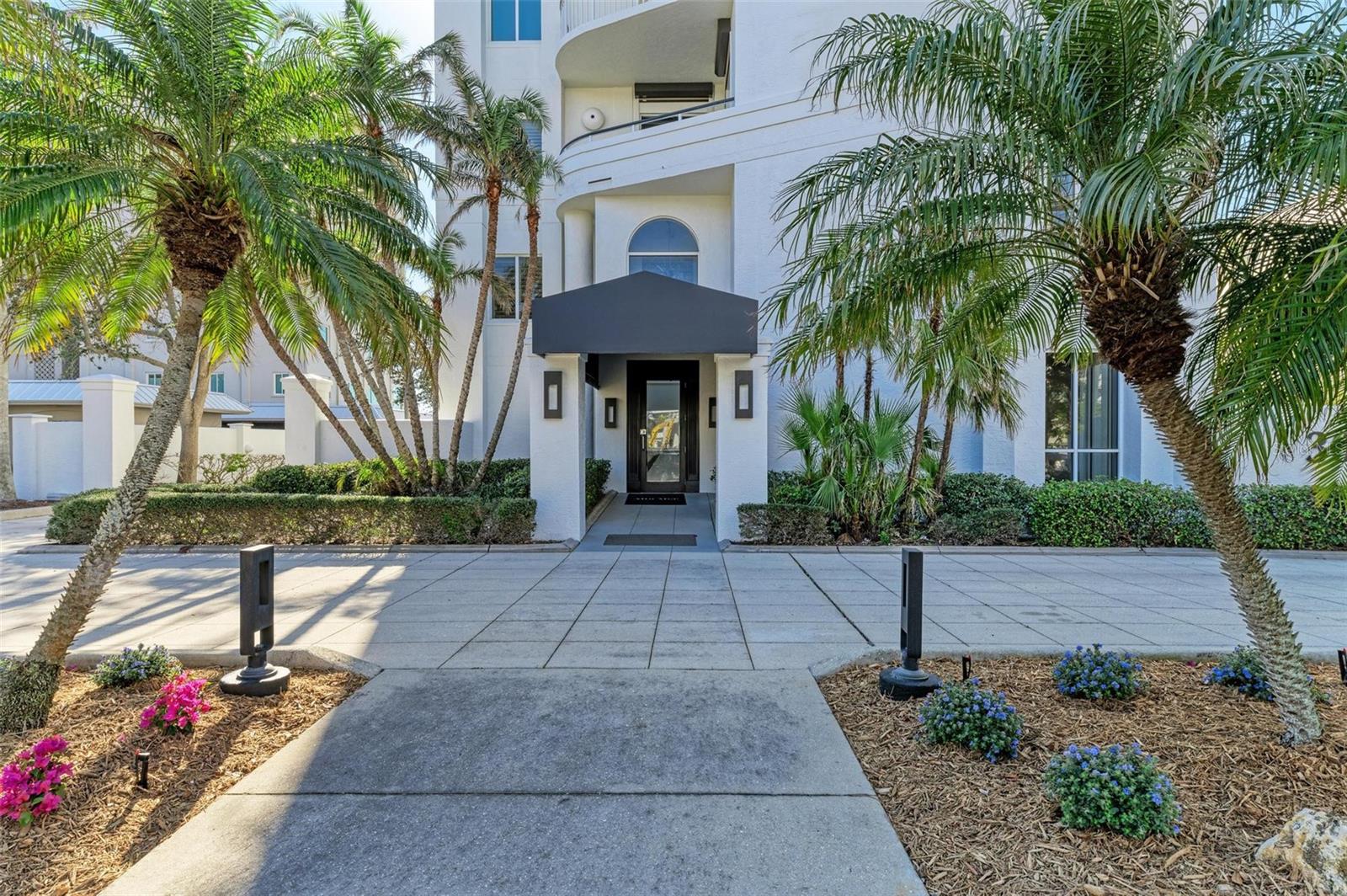 One or more photo(s) has been virtually staged. Enjoy the tranquility of coastal living while mere moments away from the vibrant arts and culture. Indulge in the mesmerizing vistas of sunrises that illuminate the John Ringling Bridge and spectacular sunsets, from your exclusive second-floor condominium overlooking Sarasota Bay. This opulent residence encompasses the entire second level of Alta Mer, providing unparalleled direct views of downtown Sarasota, the bay and beyond! Step directly into your sanctuary as the elevator opens into this luxurious abode. Three bedrooms with en suite, a gourmet kitchen, five private balconies, a two-car garage, private boat slip and dock access, fitness area and a generous pool with spa beckon discerning residents. This is living at its most exclusive, where every detail speaks of luxury and refinement. Alta Mer is a secluded and intimate boutique community comprising only six units, just beyond downtown Sarasota and at the foot of the iconic John Ringling Bridge. This location epitomizes prestige, with sidewalks lined by mature foliage winding along quaint, brick-paved streets, creating an ambiance of sophisticated intimacy. Live within distance to downtown and St. Armands Circle yet be set apart in an exclusively residential community. Oriented towards the west, residents are treated to daily spectacles of sunsets over the bay and the John Ringling Bridge, ensuring every moment at Alta Mer is a visual feast. This luxury condominium embodies the timeless real estate adage of location, location, location, and theater district and bustling heart of downtown Sarasota. Equally close is the allure of St Armands Circle and Lido Beach, offering endless possibilities for recreation and relaxation. Don't miss your chance to reside in this exceptional neighborhood, where every day promises breathtaking water views and a luxurious lifestyle!