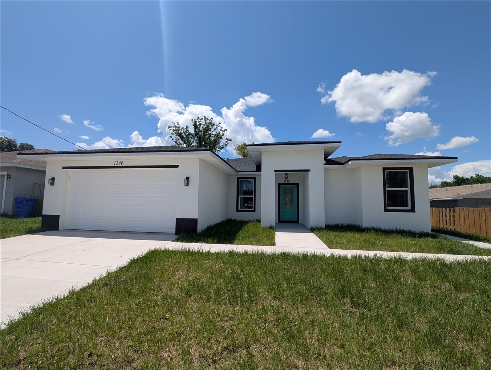 NEW 2026 LUXURY HOME, with Full Mother-in-law Suite.  Brand-new 2026 contemporary masterpiece, offering the ultimate blend of luxury, structural utility, and unparalleled location.  Sited on a modern, beautifully paved asphalt street complete with concrete sidewalks rather than older brick roads, this 100% solid concrete block and stucco home delivers ultimate peace of mind with premium built-in disaster mitigation, including high-efficiency hurricane/impact windows and a matching storm-ready exterior.  Boasting 2,028 square feet of heated living space and 2,655 total square feet under roof, this property stands completely free of any HOA or CDD restrictions and sits entirely within Flood Zone X, eliminating any requirement for costly flood insurance.  The interior is a stunning showcase of modern elegance, entirely carpet-free and dressed in premium porcelain tile flooring throughout, perfectly highlighting a bright kitchen/family room combo with soaring high ceilings, custom solid wood cabinets, and exquisite granite countertops.  A true crown jewel of this design is the fully integrated, independent In-Law Suite, which boasts its own private exterior entrance, an independent living room, a separate kitchen with granite counters, a dedicated bedroom, and a full bathroom - offering incredible multi-generational flexibility or immediate rental income potential.  There are TWO AC UNITS with separate thermostats, one for primary home and the other for he mother-in-law suite.  Shared Laundry Room is between the primary home and mother-in-law suite, separated by two exterior doors with locks.  The primary owners' suite provides a luxurious retreat with an en-suite bath and a massive walk-in closet, while the additional spacious bedrooms feature ample built-in closet space.  Outside, the property functions beautifully as a private oasis, featuring a large fenced yard, a covered rear porch/lanai for outdoor enjoyment, and a generous attached 2-car garage.  Unbeatably located just a 1-mile, 5-minute drive from the famous 168-acre Bonnet Springs Park urban-nature retreat, and only moments from vibrant Downtown Lakeland, Lake Beulah, and the RP Funding Center, this property also offers ultimate daily convenience with an array of nearby shopping and dining options—including Publix, Target, Starbucks, and a Walmart Supercenter all just a short 5-minute drive away—making this premium estate a rare opportunity to own the area's finest multi-generational luxury build.