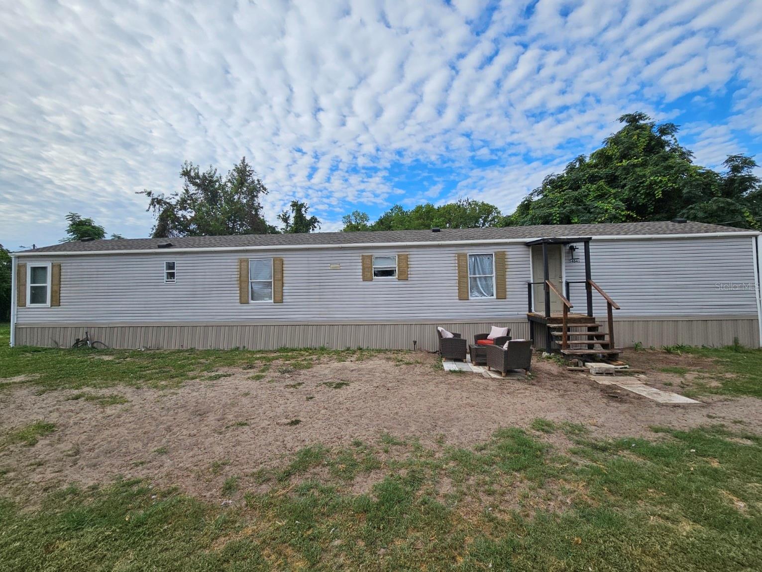 Welcome home to this charming 3-bedroom, 2-bathroom single wide manufactured home nestled on 0.22 acres in the desirable Little Lake Weir community of Summerfield, FL. Built in 1998 and featuring an open floorplan with a kitchen/family room combo, this home boasts newer vinyl flooring throughout the entire home, granite countertops in the kitchen, and a newer central heat and air system for year-round comfort. Enjoy the convenience of being just minutes from The Villages, major shopping, dining, and entertainment — all with NO HOA and NO CDD fees. The property sits on a paved road and is fully fenced with board fencing. Utilities include well water and septic. Zoned R4 with a lot size of 75x130 ft. Cash, Conventional, VA, USDA and FHA financing welcome. Schedule your showing today!