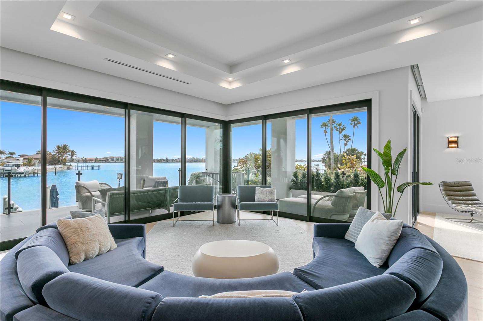 One of the best, strongest homes ever constructed in Pass A Grille Beach. This waterfront fortress sits on an oversized lot with amazing views of the intra-coastal waterway, perfect for sunrises and sunsets. This entire home is a custom masterpiece that was thoughtfully built. It is a wonderful blend of modern clean lines and coastal warmth. The location could not be more perfect. You can walk 600 ft to the beautiful sands of Pass A Grille Beach but also enjoy a private waterfront backyard, facing East for shaded afternoons complete with heated saltwater pool and spa. The backyard features a PGA putting green and new turf throughout the property. It is the ONLY home in Pass A Grille in the No Wake Zone that has a wide open water view! For boating, no bridges to the Gulf of America, straight shot south, less than a mile away. You are minutes from the interstate if you wish to travel, or you can walk to local shops and restaurants. With a south side street to access your driveway, you have plenty of private parking for guests. This property has many features that are unique to the area, that may not be able to be duplicated ever again.
